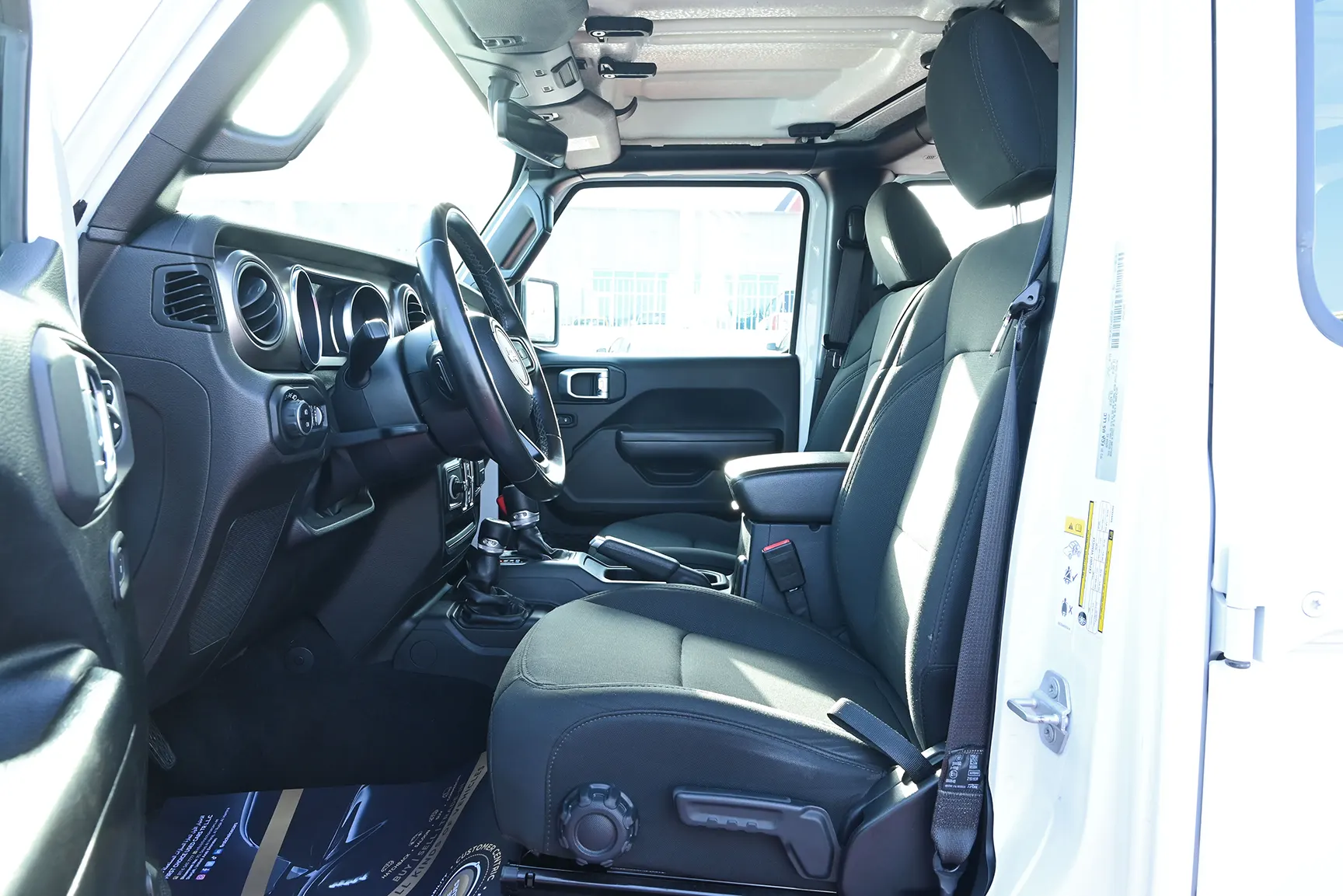 Used 2019 Jeep Wrangler Unlimited Sport White – Front Driver Side Cabin View at First Choice Cars Sharjah