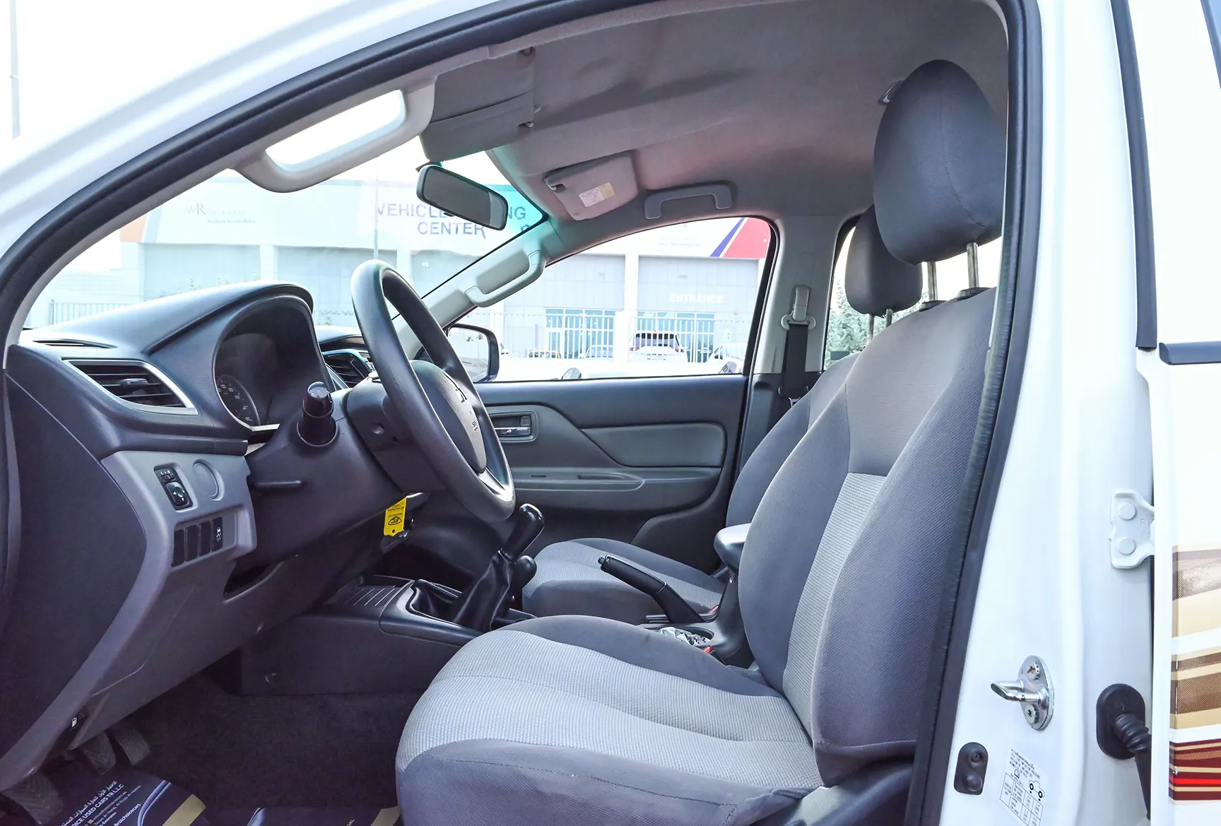 Used 2018 Mitsubishi L200 Double Cab GL White – Front Driver Side Cabin View at First Choice Cars Sharjah