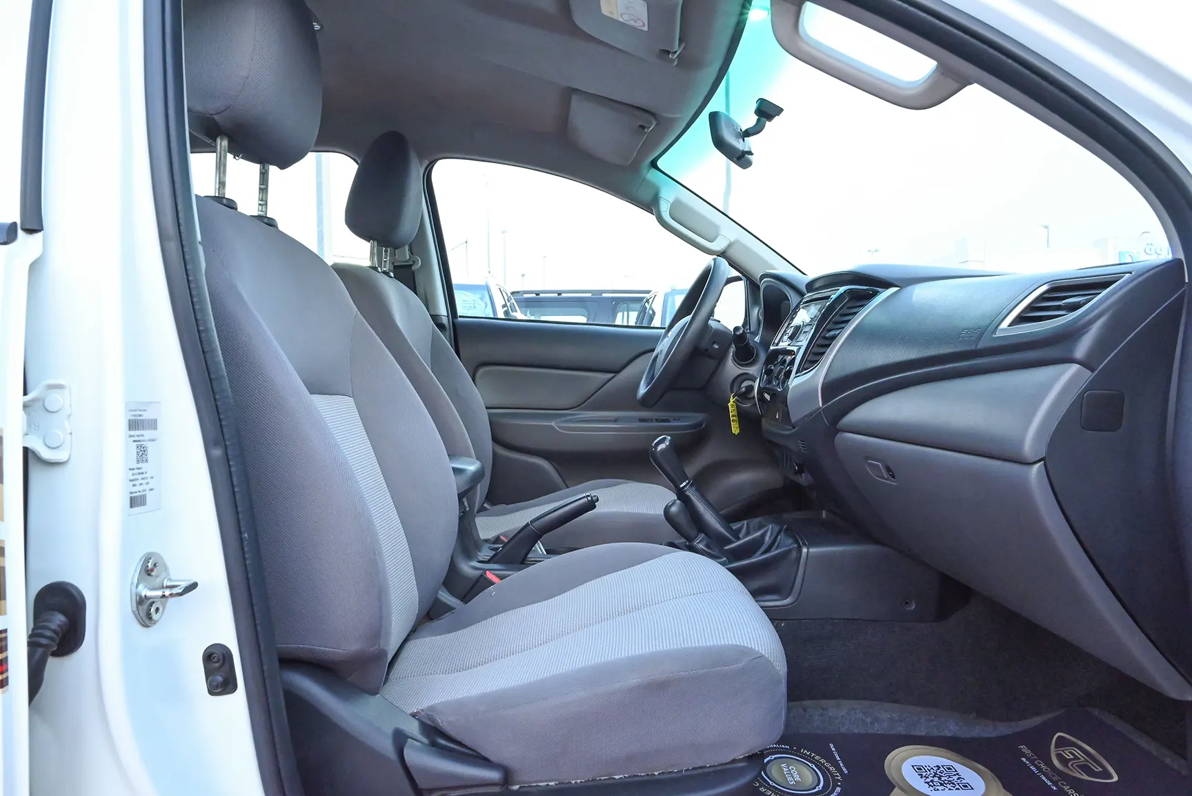 Used 2018 Mitsubishi L200 Double Cab GL White – Front Passenger Side Cabin View at First Choice Cars Sharjah