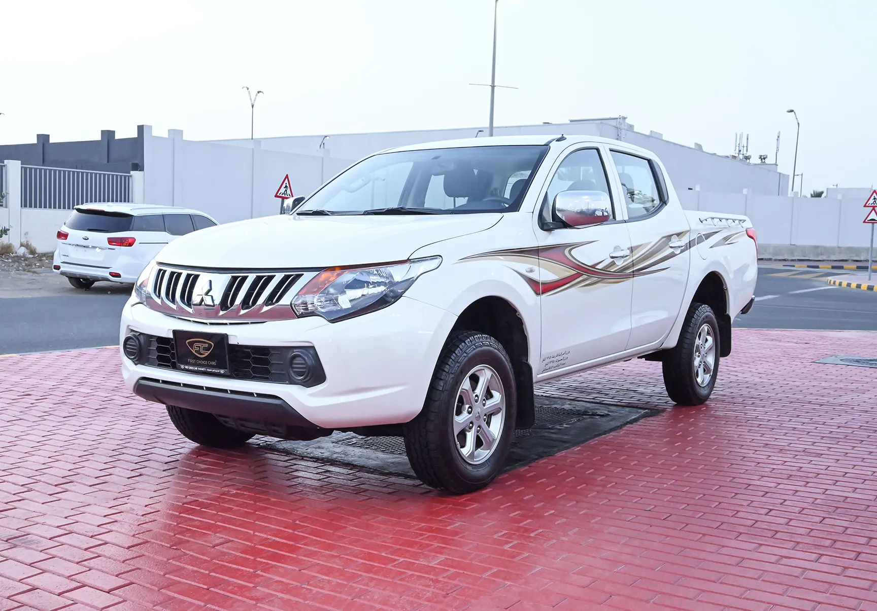 Used 2018 Mitsubishi L200 GL Double Cabin in White – Left Front Diagonal (45°) View for Sale at First Choice Cars Dubai Sharjah