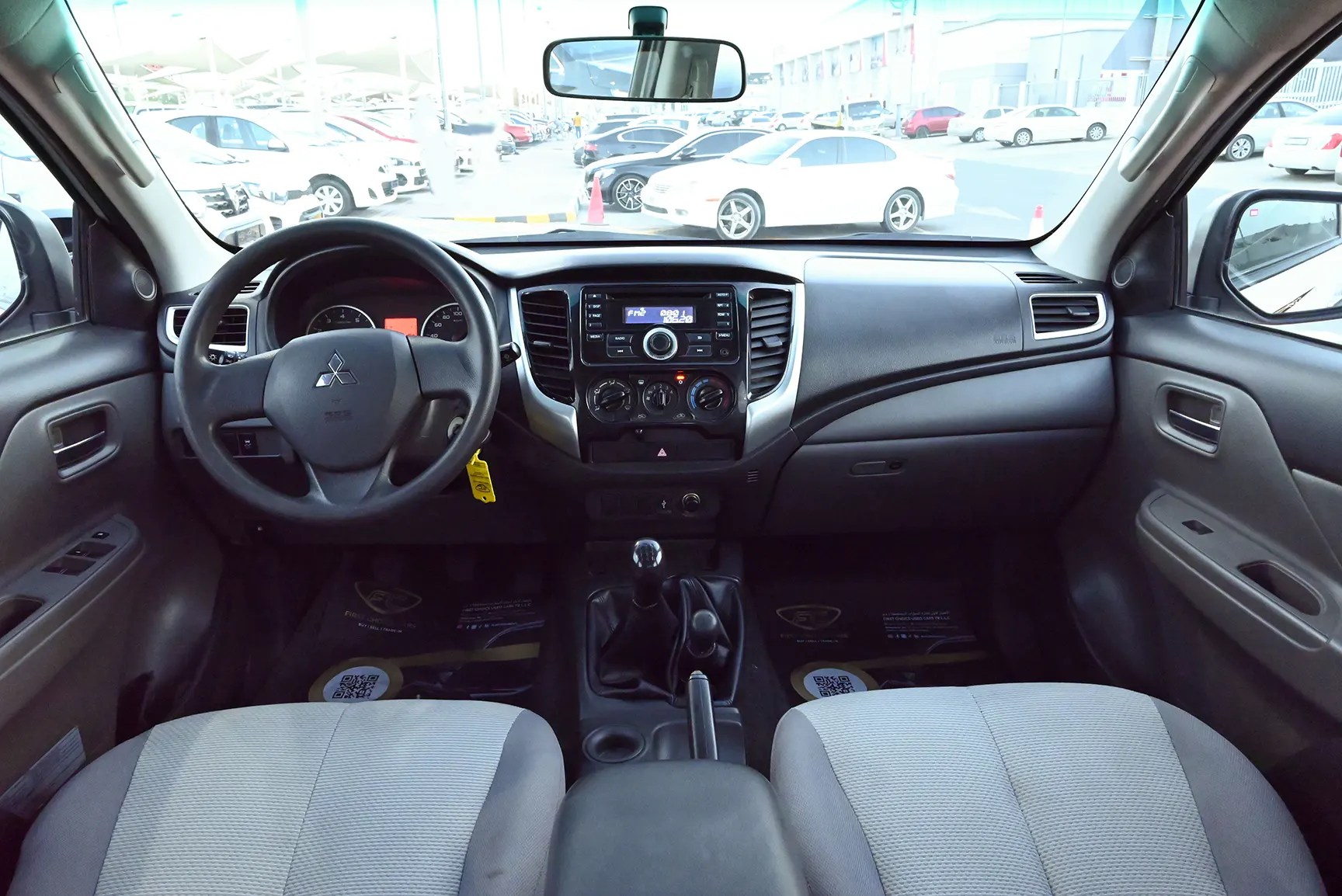 Used 2018 Mitsubishi L200 GL Double Cabin in White – Front Cabin / Dashboard Full View for Sale at First Choice Cars Dubai Sharjah