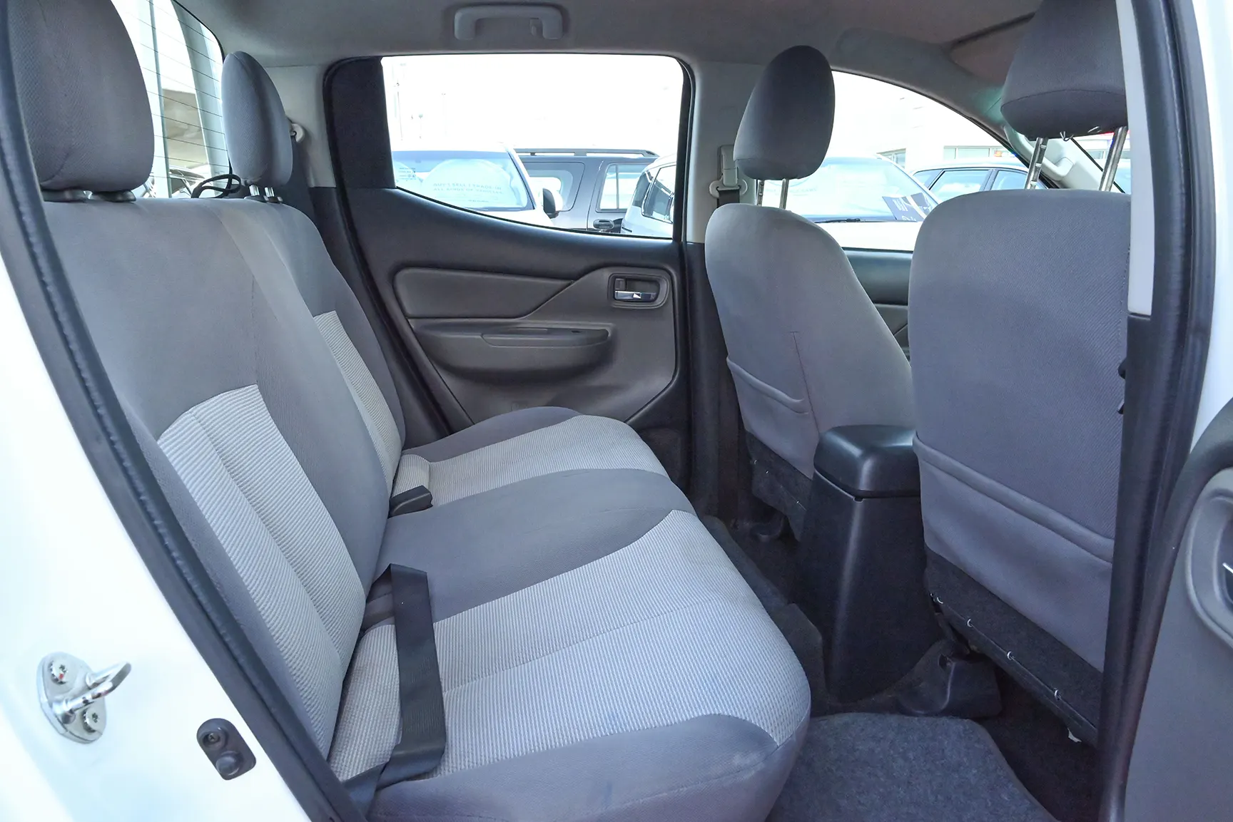 Used 2018 Mitsubishi L200 GL Double Cabin in White – Rear Passenger Side Cabin View for Sale at First Choice Cars Dubai Sharjah