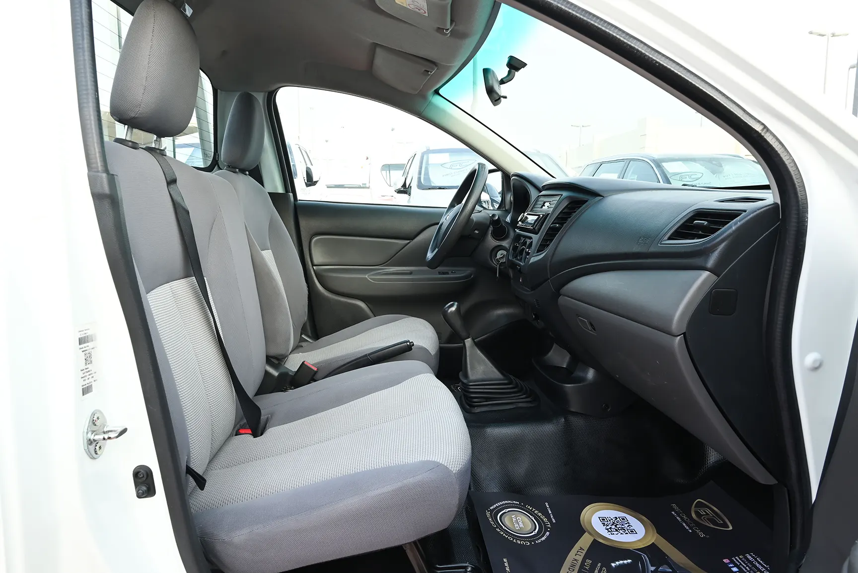 Used 2018 Mitsubishi L200 Single Cab GL White – Front Passenger Side Cabin View at First Choice Cars Sharjah