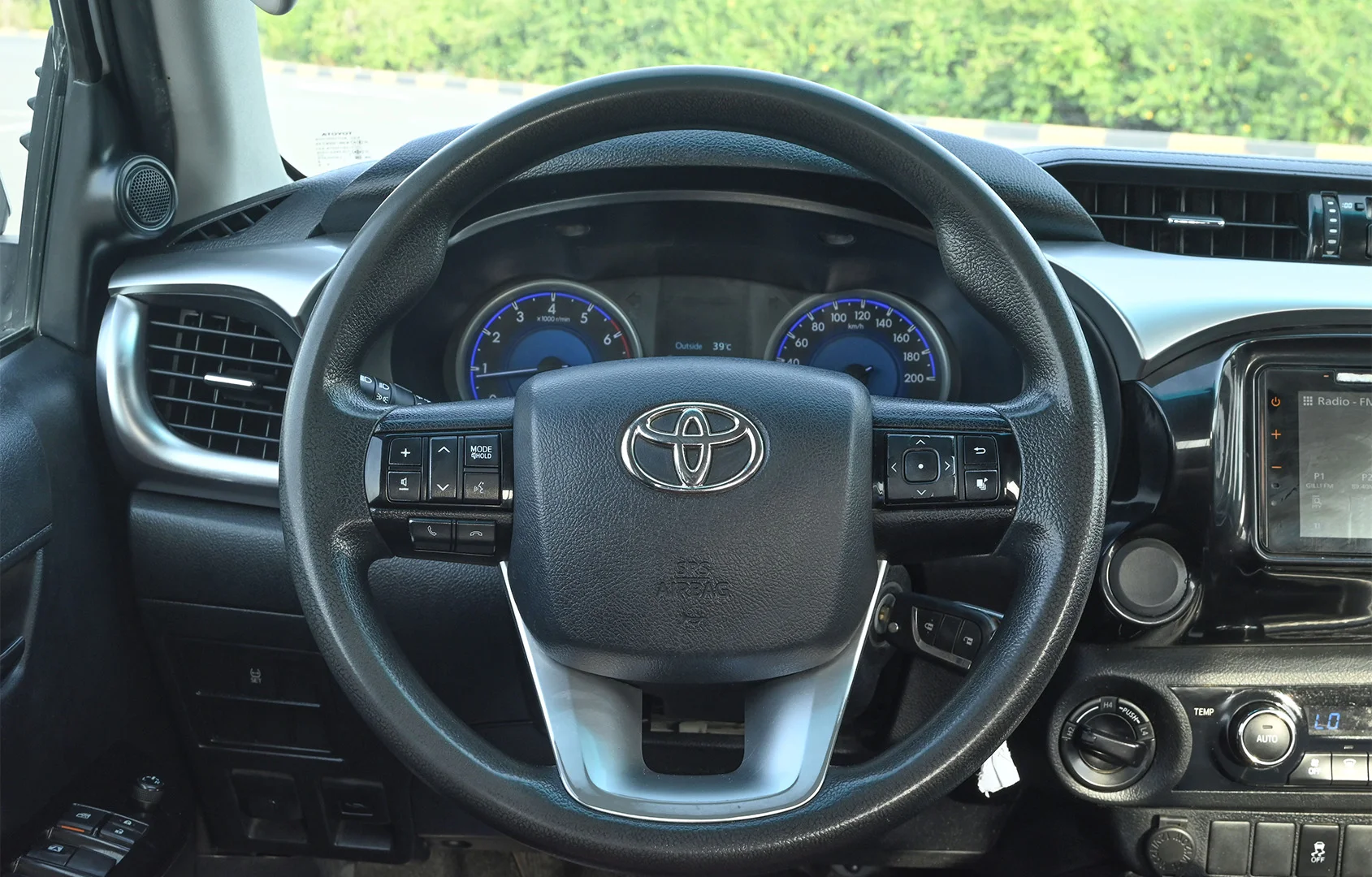 Used 2020 Toyota Hilux GLX Double Cabin White – Driver Side Dashboard & Steering View at First Choice Cars Sharjah