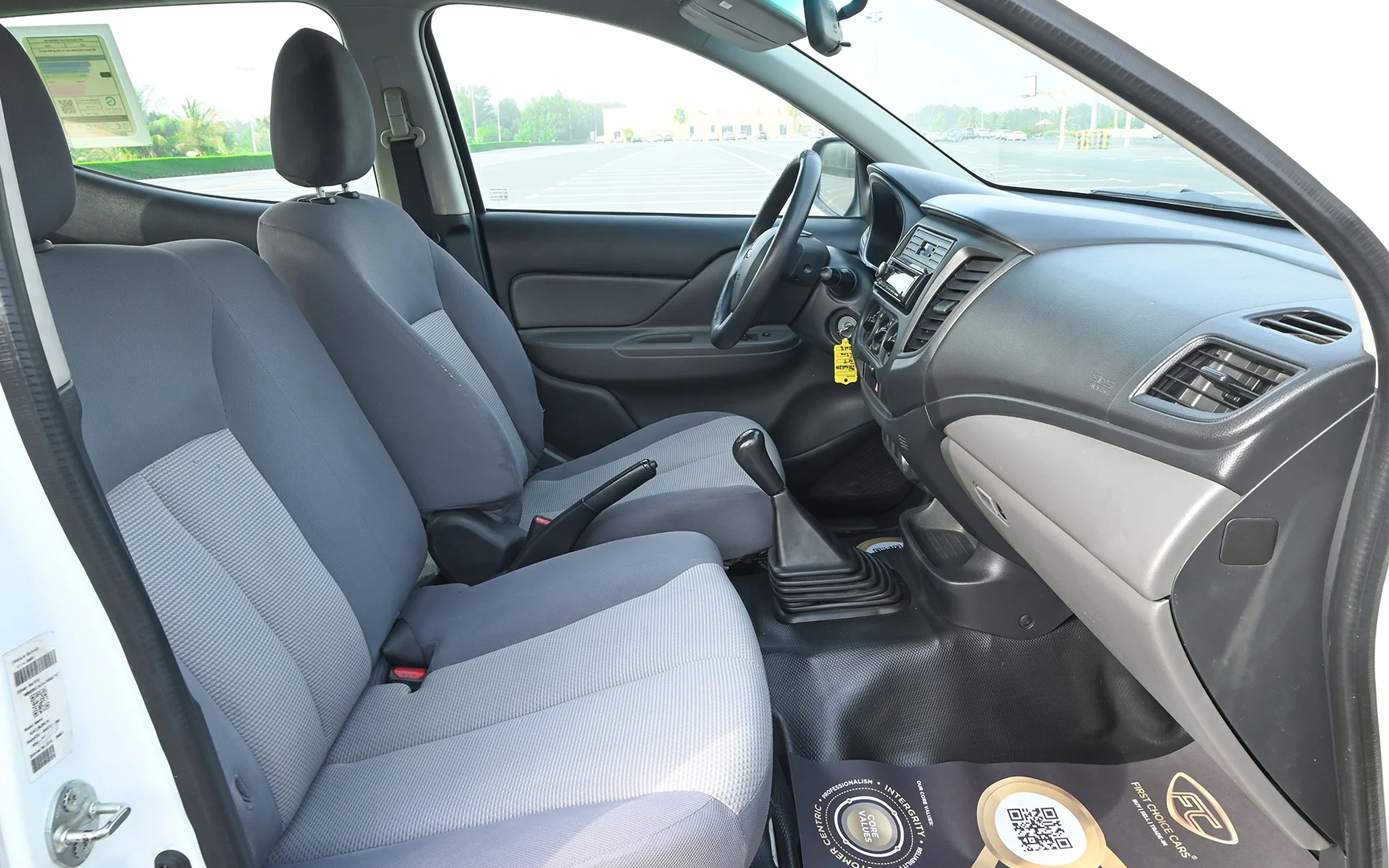 Used 2018 Mitsubishi L200 GL Double Cabin in White – Front Passenger Side Cabin View for Sale at First Choice Cars Dubai Sharjah