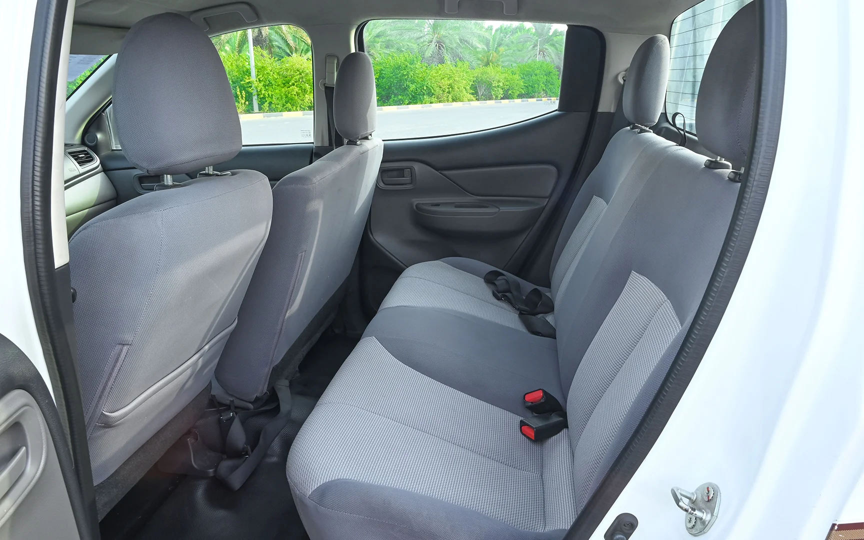 Used 2018 Mitsubishi L200 GL Double Cabin in White – Rear Driver Side Cabin View for Sale at First Choice Cars Dubai Sharjah