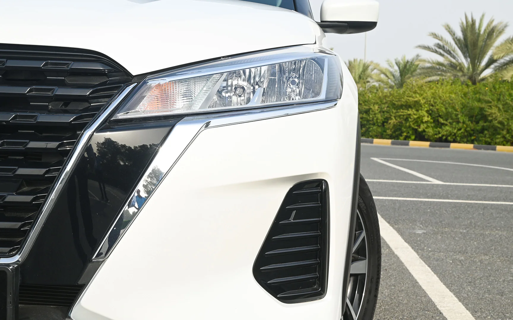 Used 2022 Nissan Kicks S White – Headlight Close-up at First Choice Cars Sharjah