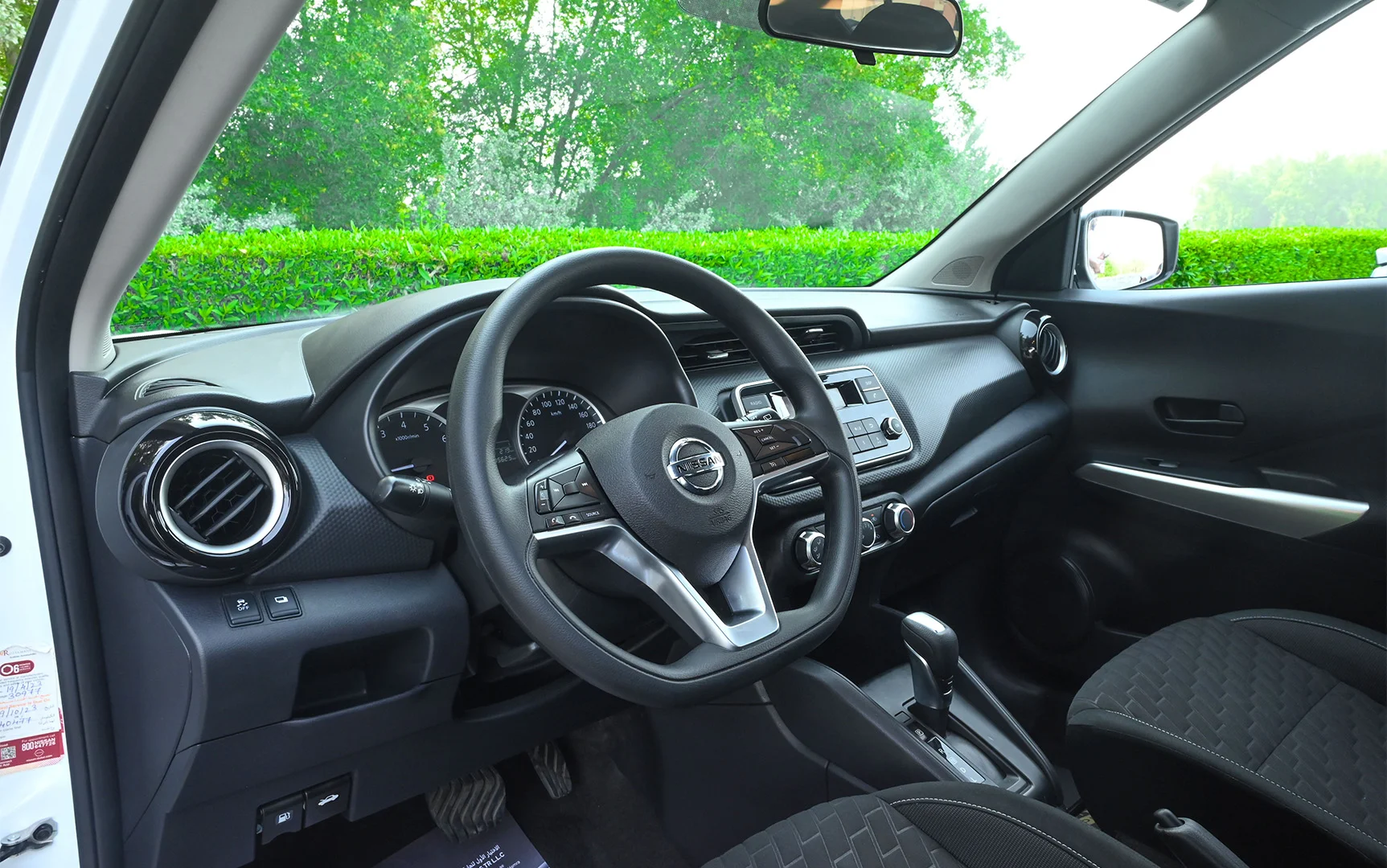 Used 2022 Nissan Kicks S White – Driver Side Dashboard & Steering View at First Choice Cars Sharjah