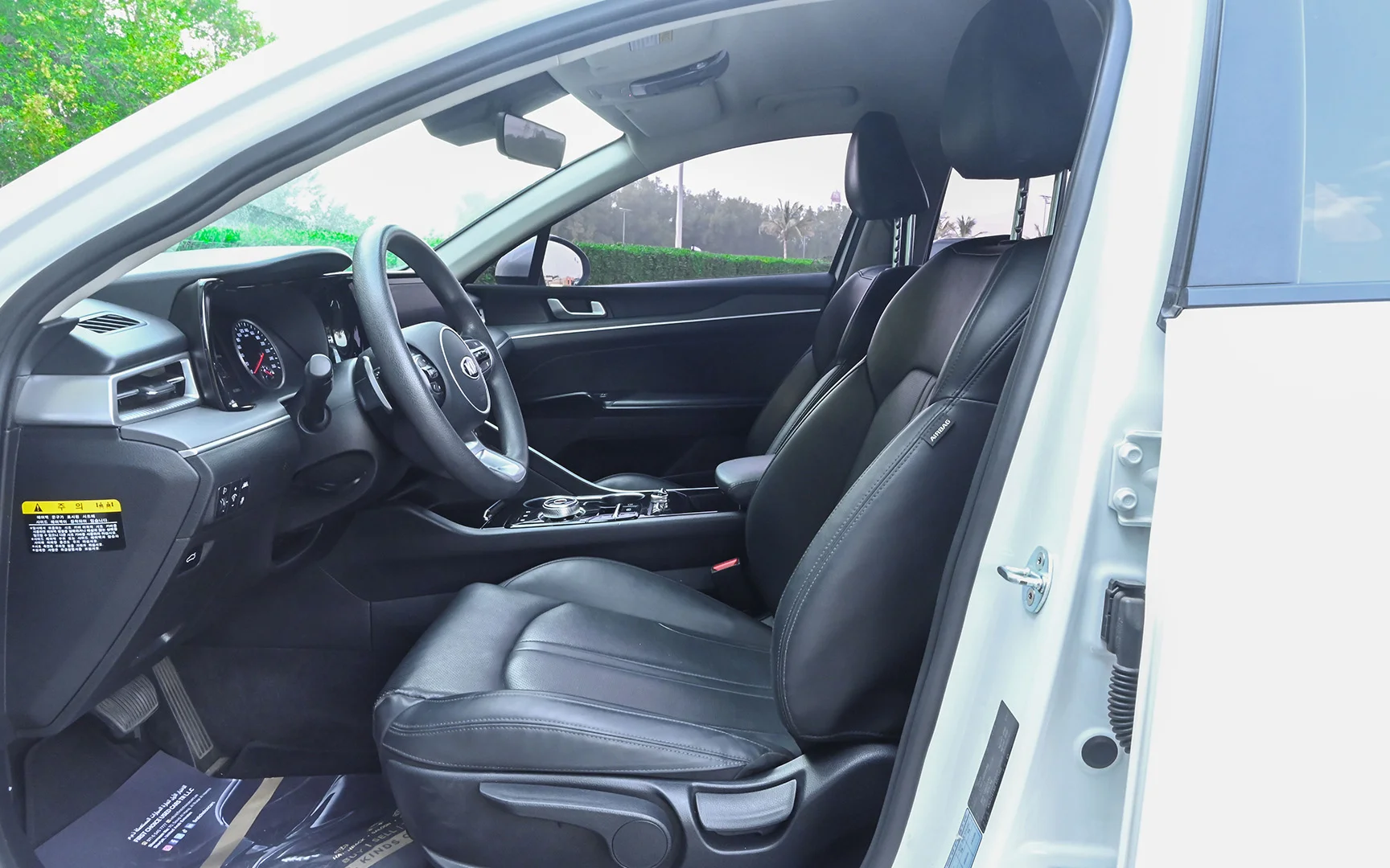Used 2020 Kia K5 LX in White – Front Driver Side Cabin View for Sale at First Choice Cars Dubai Sharjah