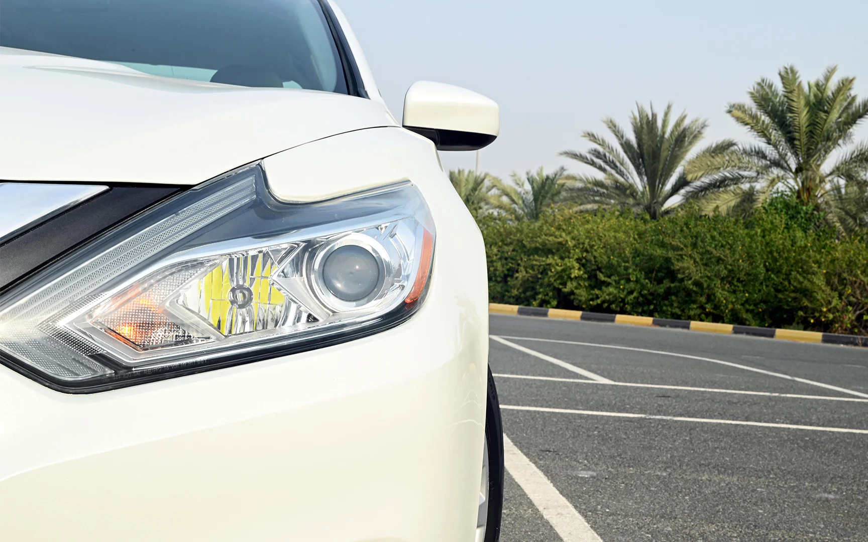 Used 2018 Nissan Altima S White – Headlight Close-up at First Choice Cars Sharjah