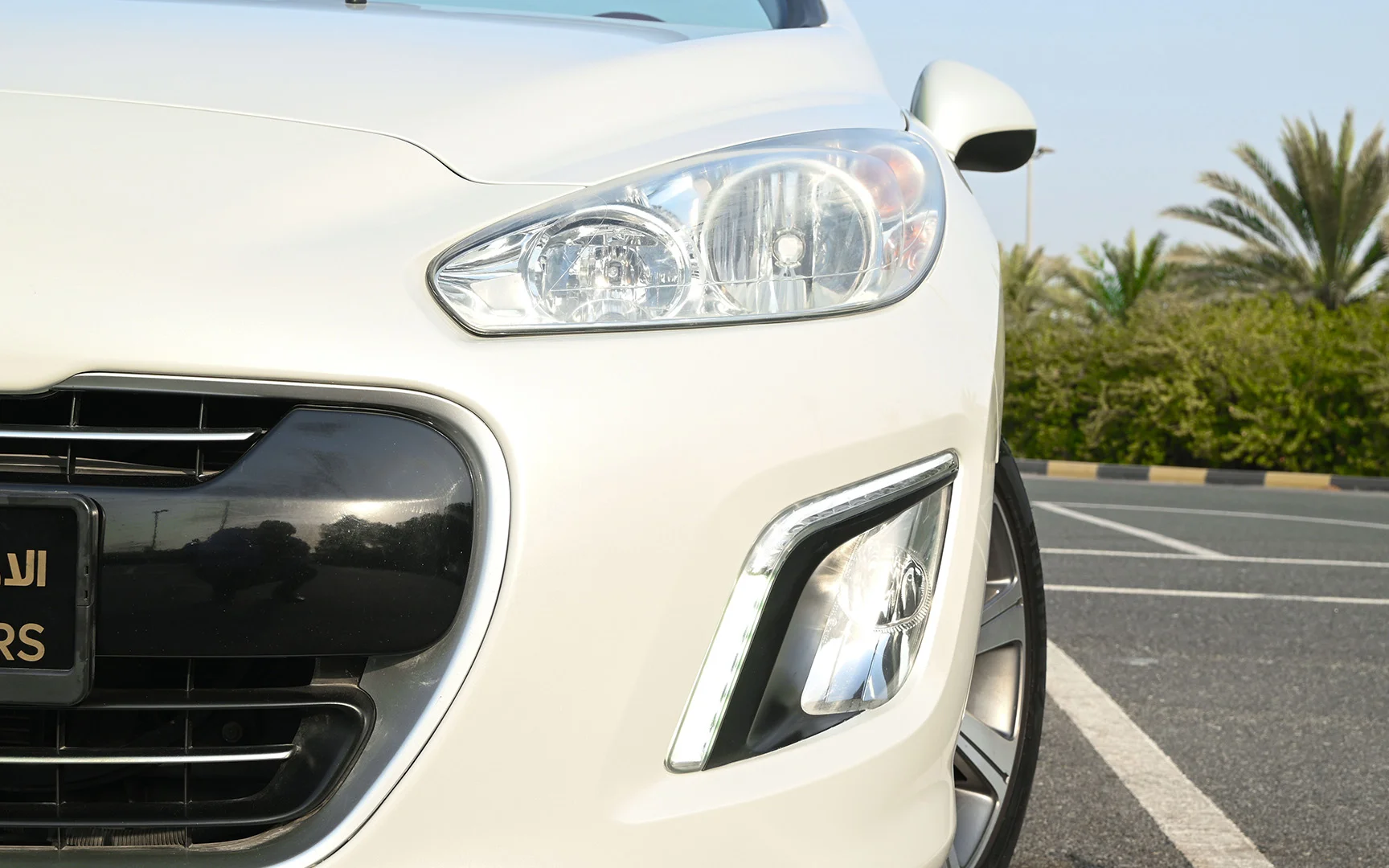 Used 2014 Peugeot 308 CC Convertible White – Headlight Close-up at First Choice Cars Sharjah