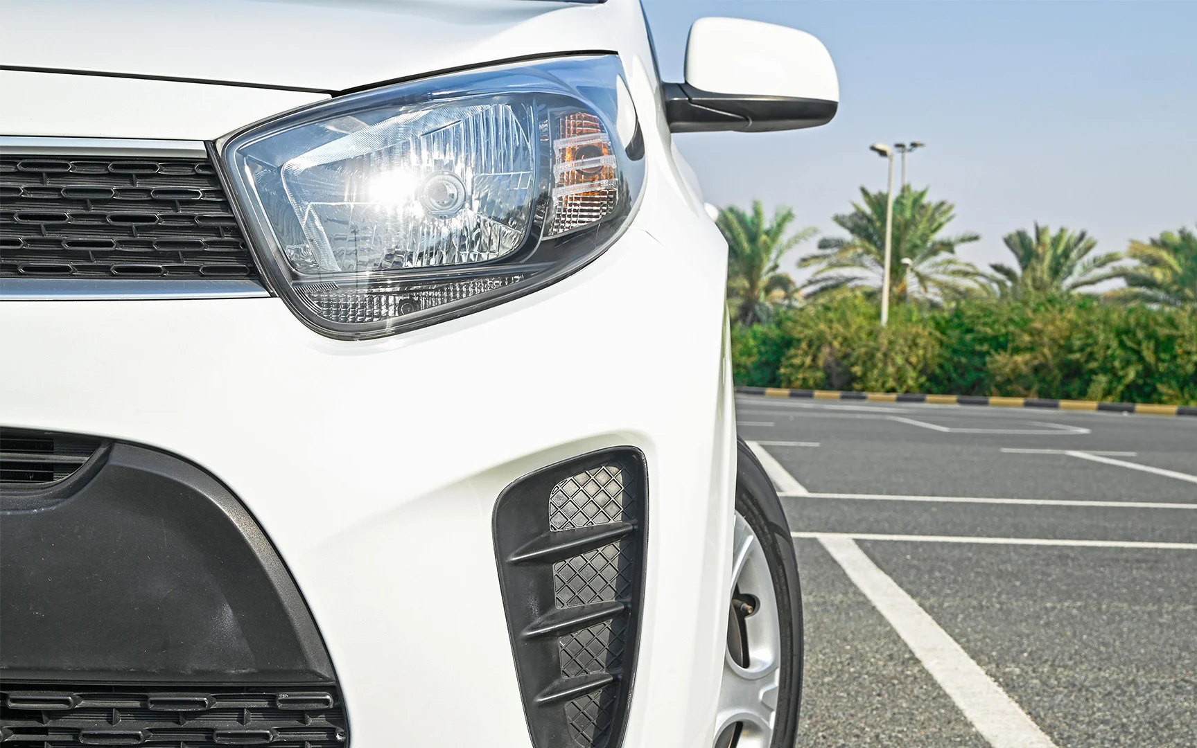 Used 2019 KIA Picanto LX White – Headlight Close-up at First Choice Cars Sharjah