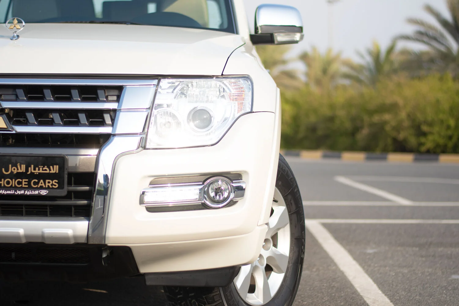 Used 2019 Mitsubishi PAJERO GLS White – Headlight Close-up at First Choice Cars Sharjah