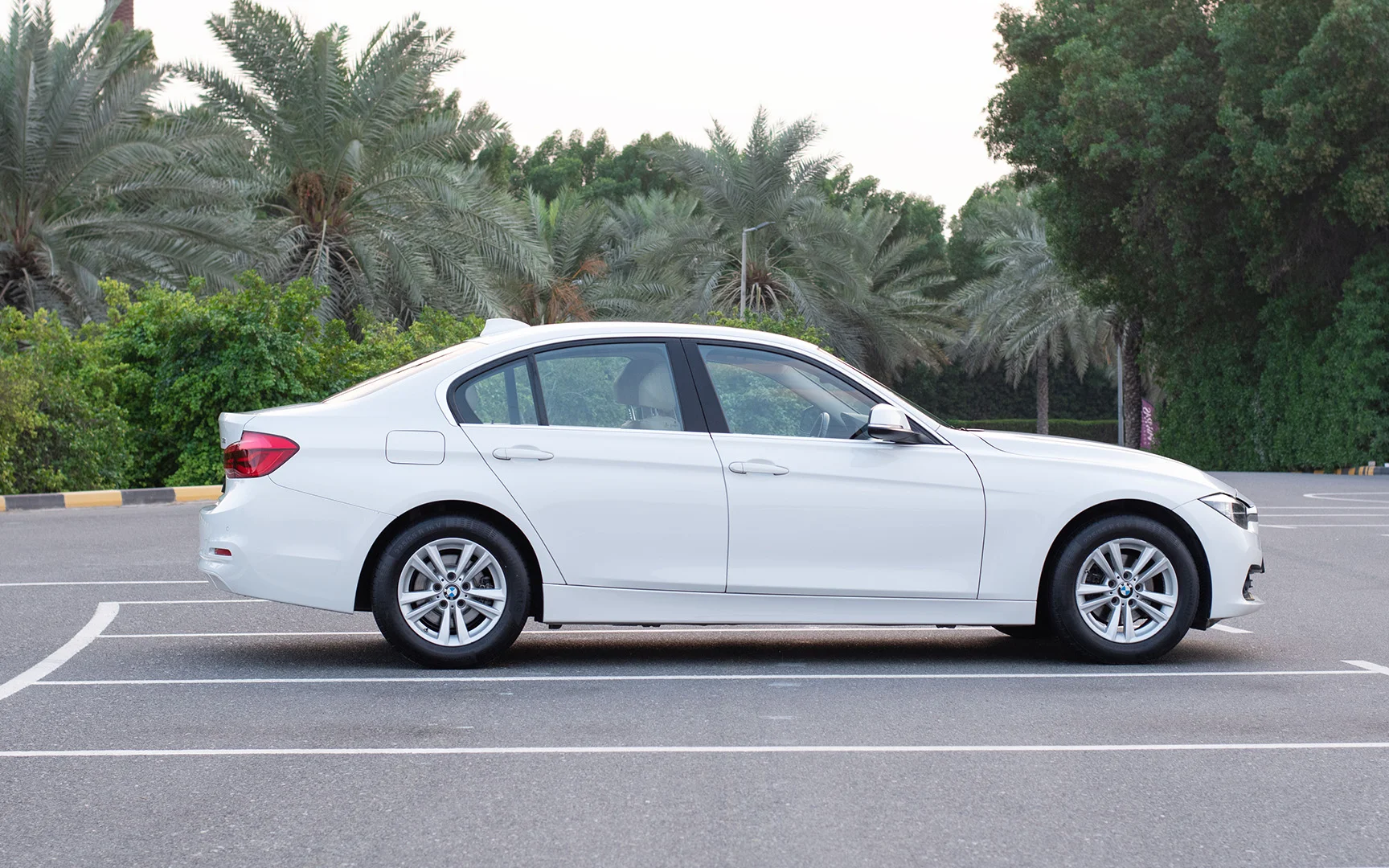 Used 2017 BMW 3-Series 318i White – Left Side View at First Choice Cars Sharjah