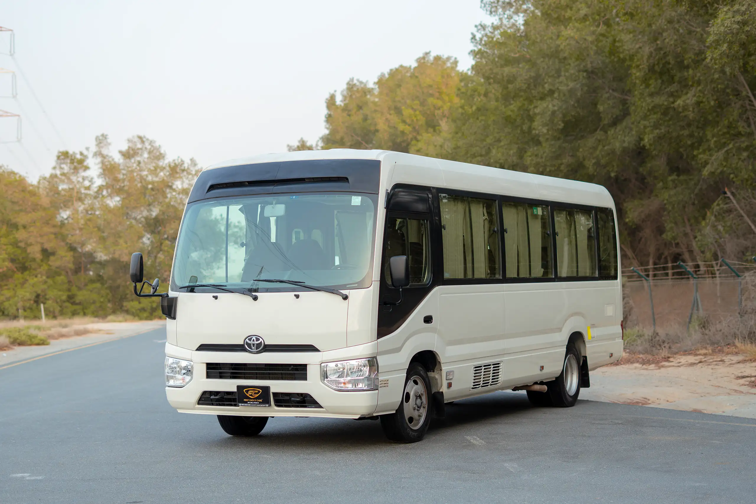 Used 2020 Toyota Coaster High Roof in White – Left Front Diagonal (45°) View for Sale at First Choice Cars Dubai Sharjah