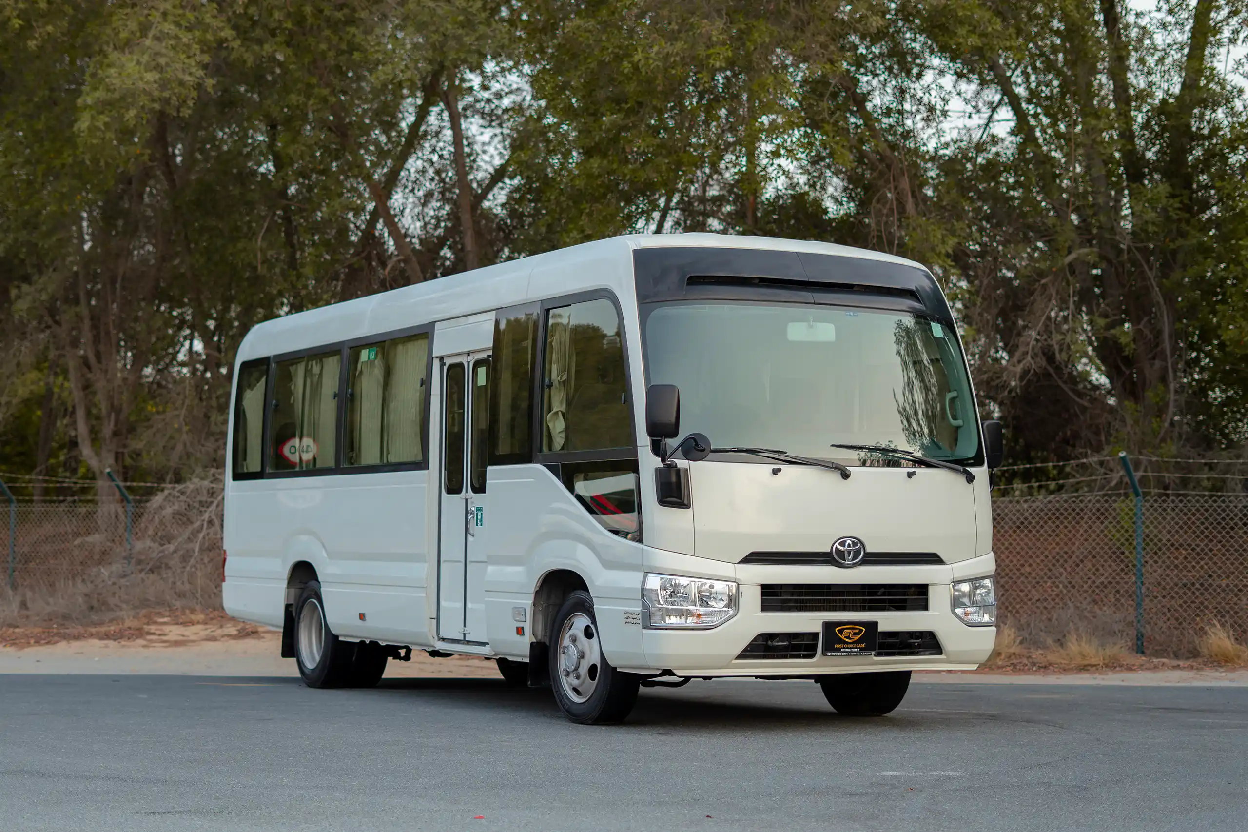 Used 2020 Toyota Coaster High Roof in White – Right Front Diagonal (45°) View for Sale at First Choice Cars Dubai Sharjah