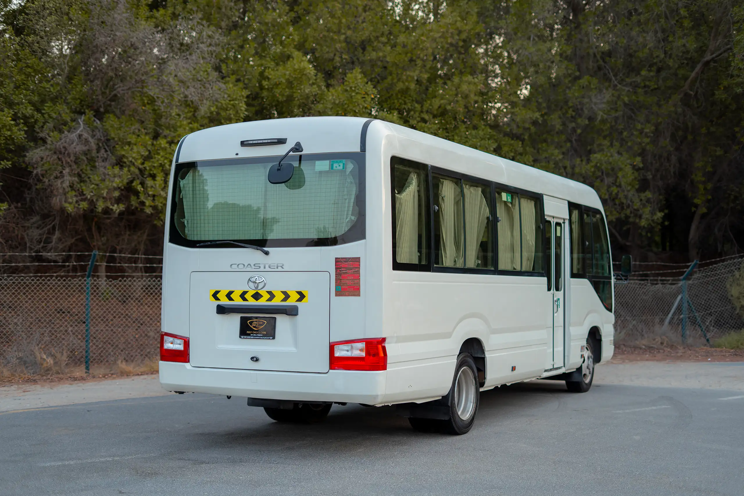 Used 2020 Toyota Coaster High Roof in White – Left Back Diagonal (45°) View for Sale at First Choice Cars Dubai Sharjah