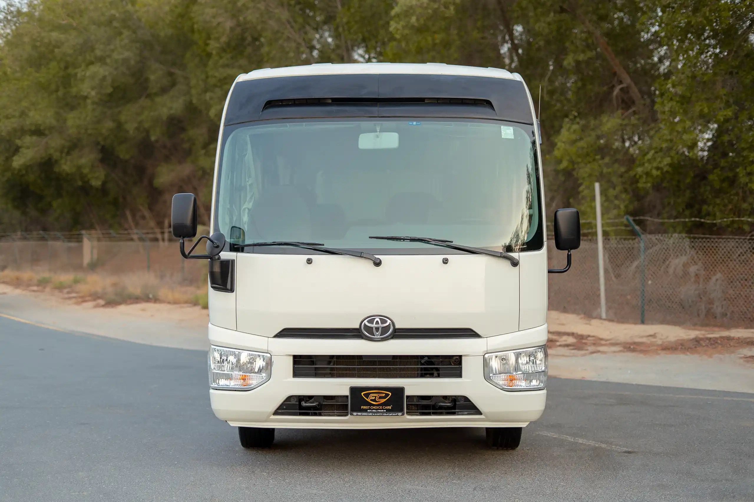 Used 2020 Toyota Coaster High Roof in White – Front View for Sale at First Choice Cars Dubai Sharjah