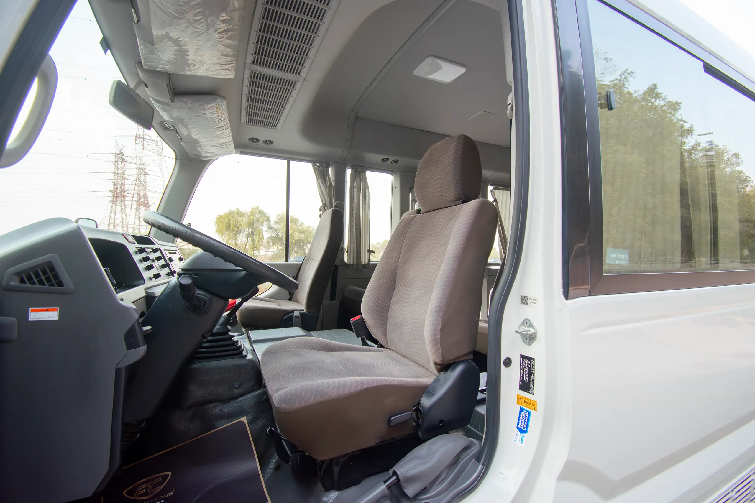 Used 2020 Toyota Coaster High Roof in White – Front Driver Side Cabin View for Sale at First Choice Cars Dubai Sharjah