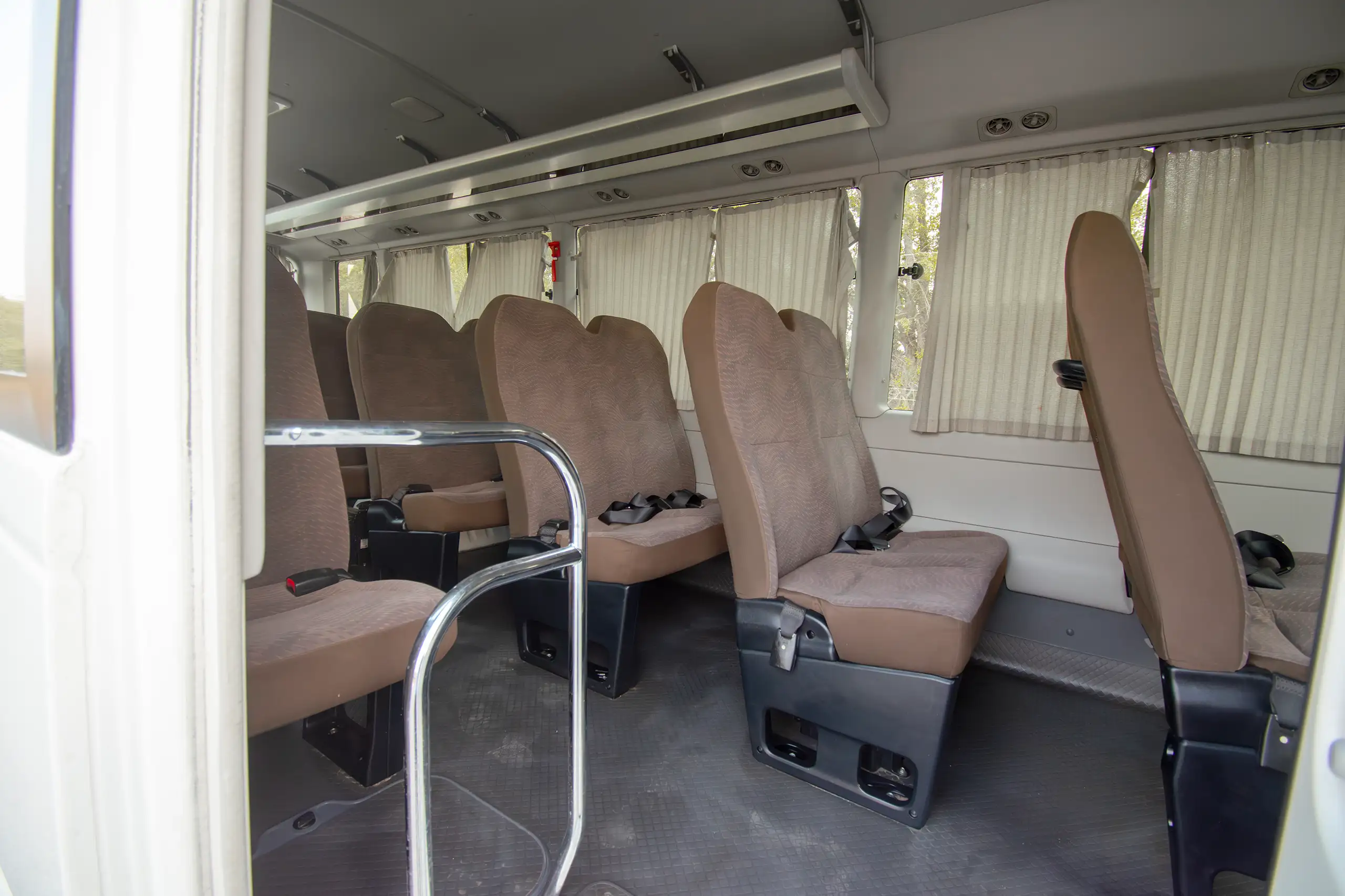 Used 2020 Toyota Coaster High Roof in White – Rear Passenger Side Cabin View for Sale at First Choice Cars Dubai Sharjah
