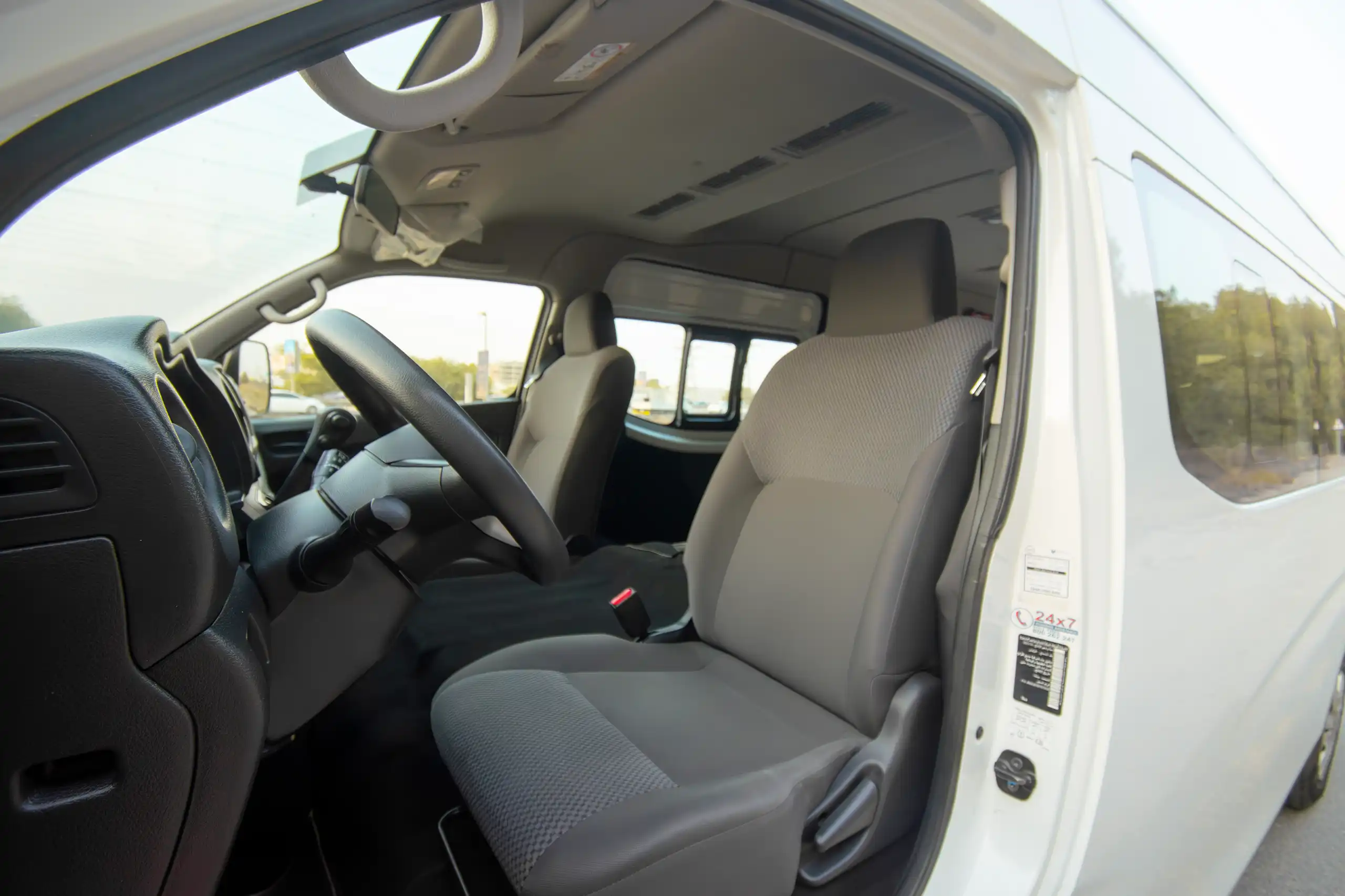 Used 2023 Nissan Urvan High Roof in White – Front Driver Side Cabin View for Sale at First Choice Cars Dubai Sharjah