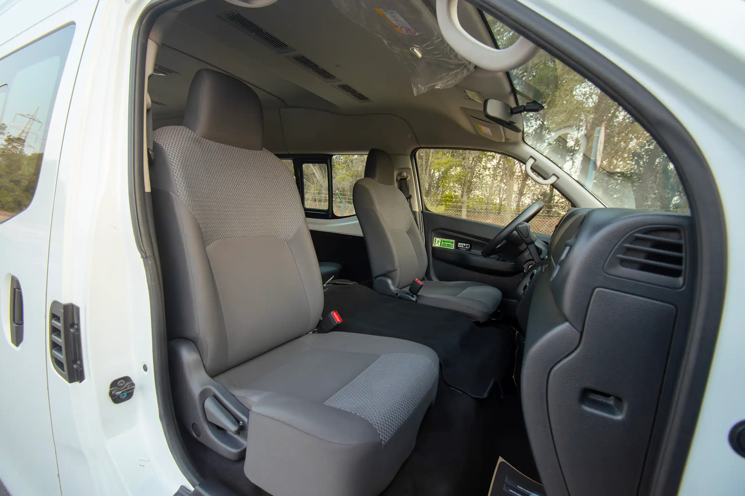 Used 2023 Nissan Urvan High Roof in White – Front Passenger Side Cabin View for Sale at First Choice Cars Dubai Sharjah