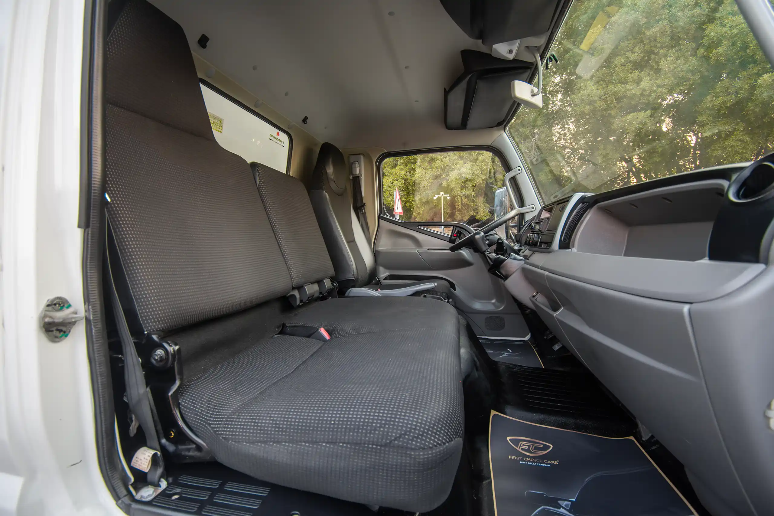 Used 2020 Mitsubishi Canter Cargo Box in White – Front Passenger Side Cabin View for Sale at First Choice Cars Dubai Sharjah