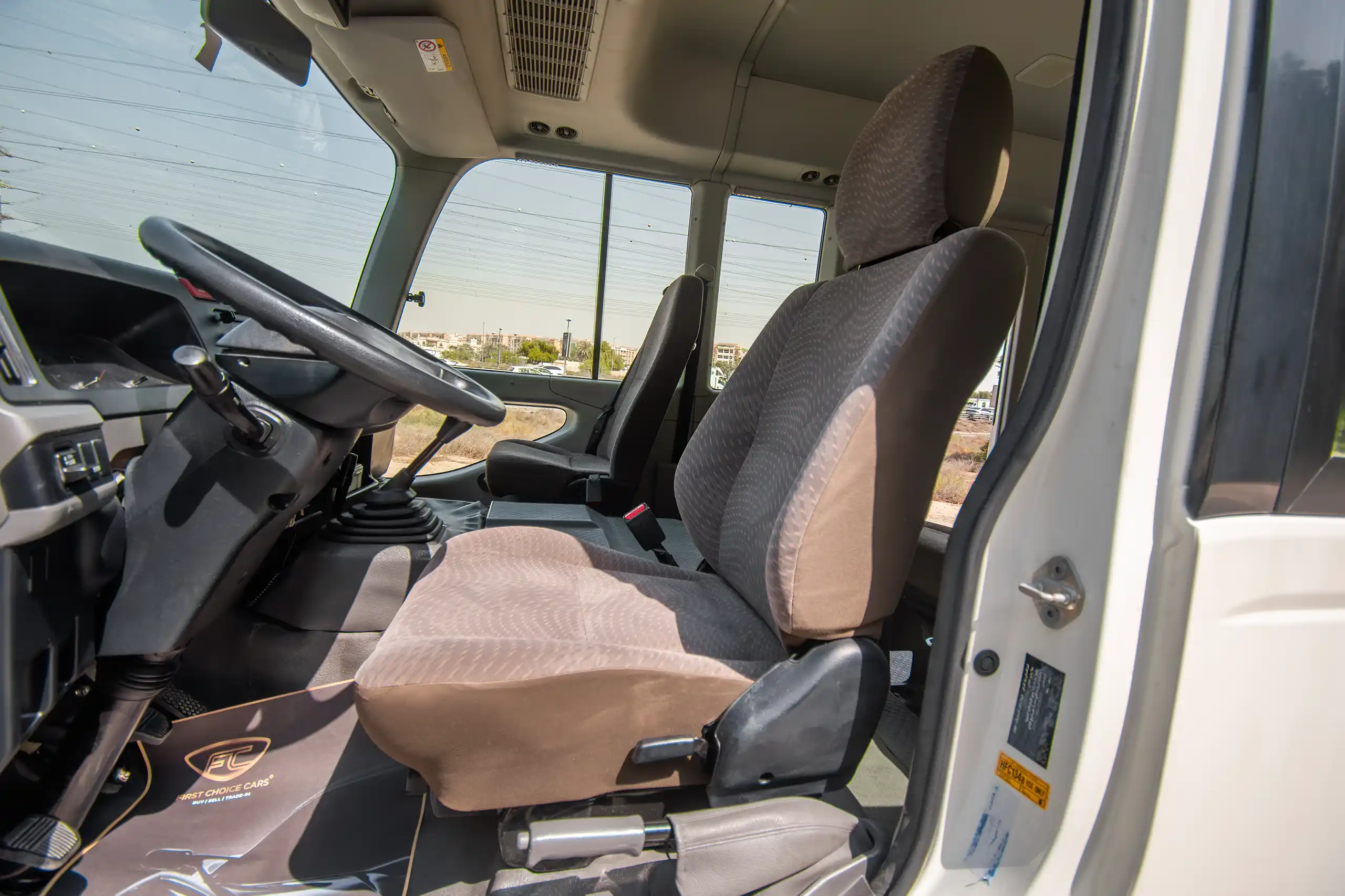 Used 2020 Toyota Coaster Bus White – Front Driver Side Cabin View at First Choice Cars Sharjah