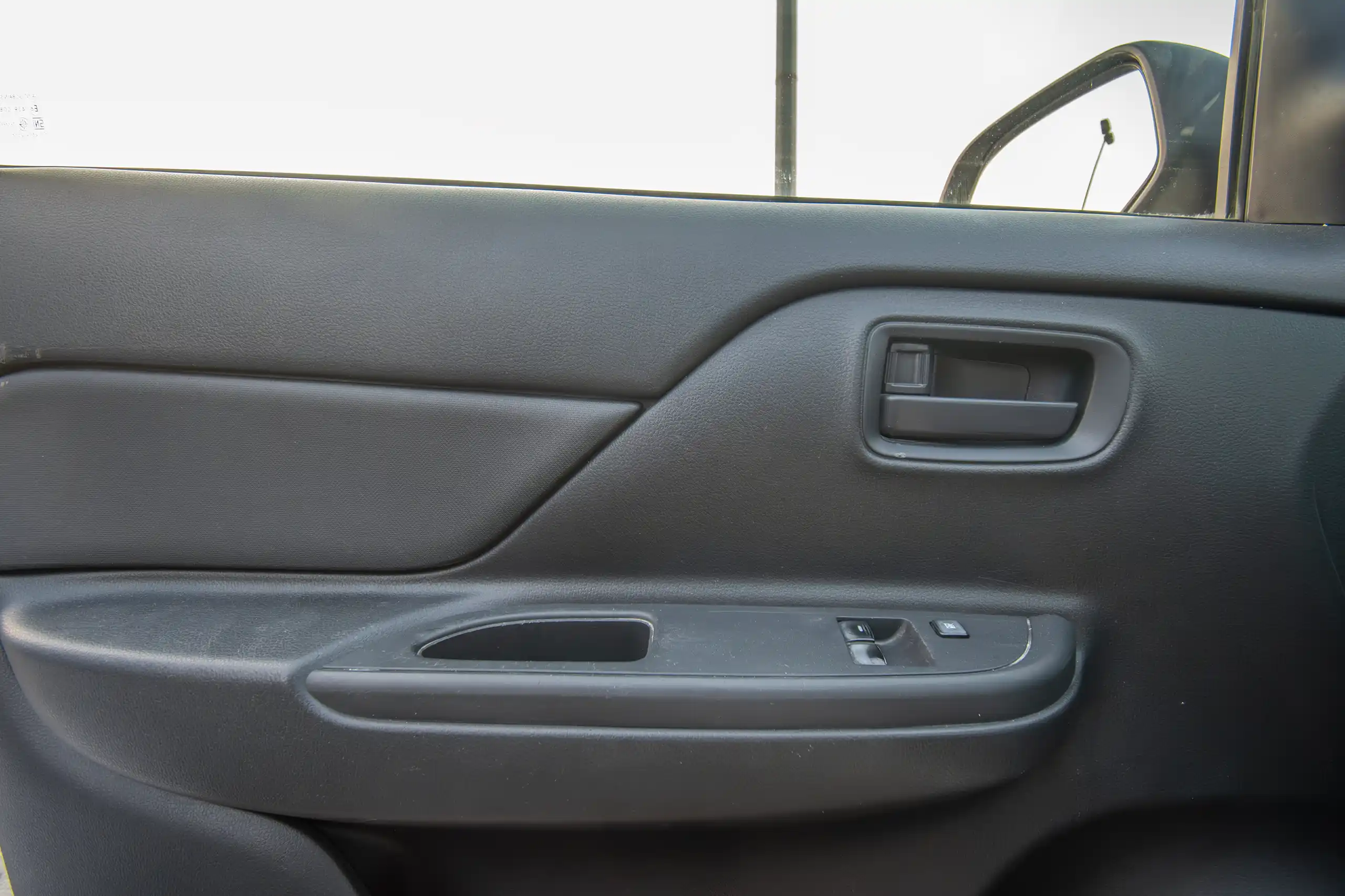 Used 2021 Mitsubishi L200 GL Single Cabin in White – Driver Door Panel Full View for Sale at First Choice Cars Dubai Sharjah