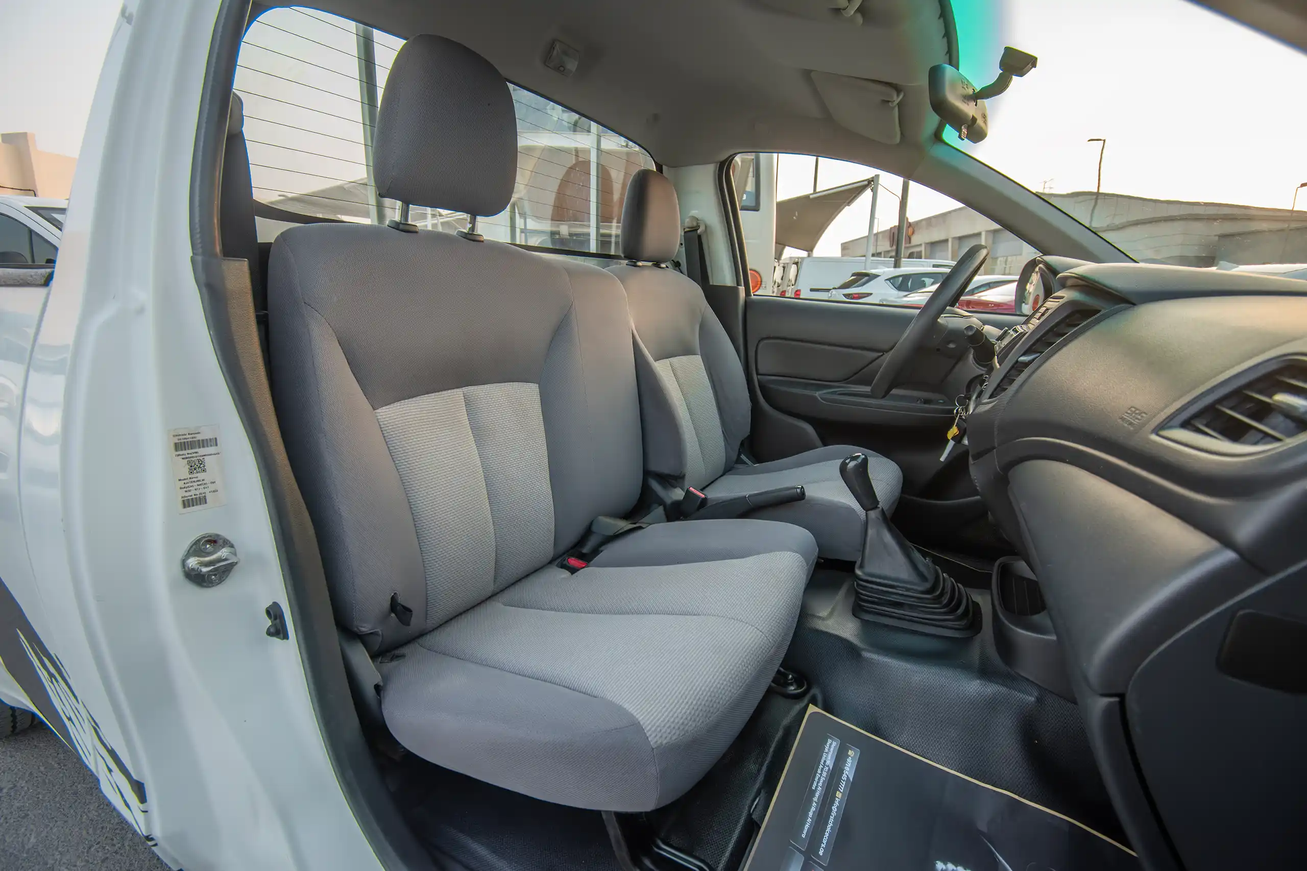 Used 2021 Mitsubishi L200 Single Cab GL White – Front Passenger Side Cabin View at First Choice Cars Sharjah