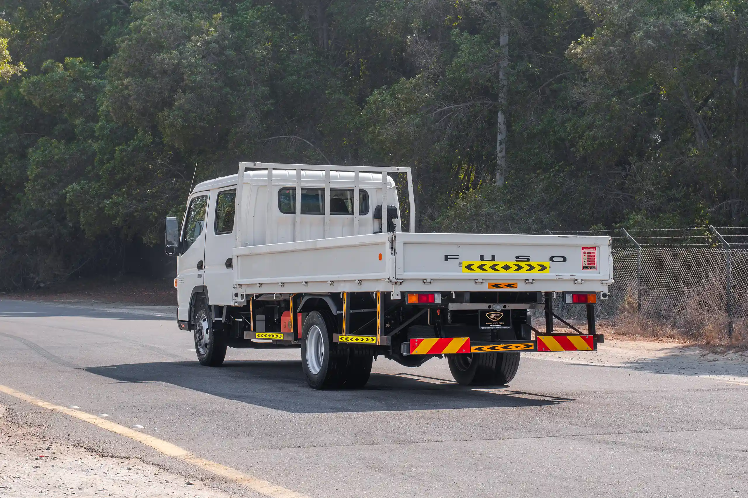 Used 2023 Mitsubishi Canter Double Cabin Cargo Body White – Left Back Diagonal (45°) View at First Choice Cars Sharjah