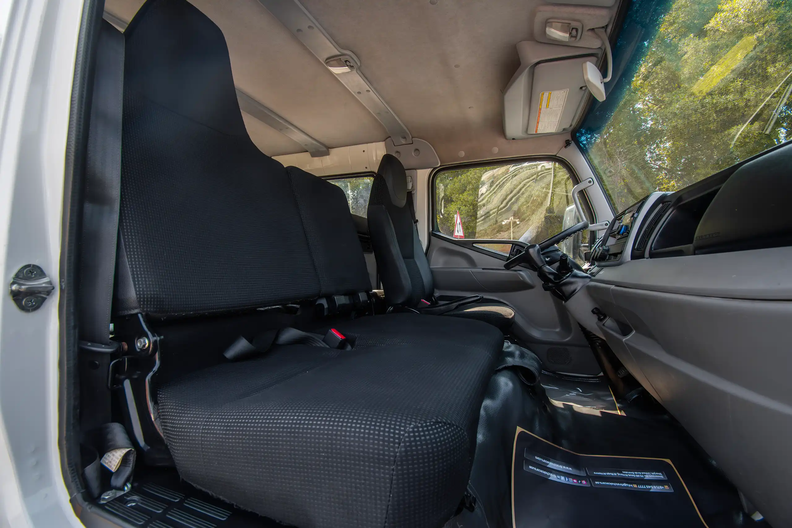 Used 2023 Mitsubishi Canter Double Cabin Cargo Body White – Front Passenger Side Cabin View at First Choice Cars Sharjah