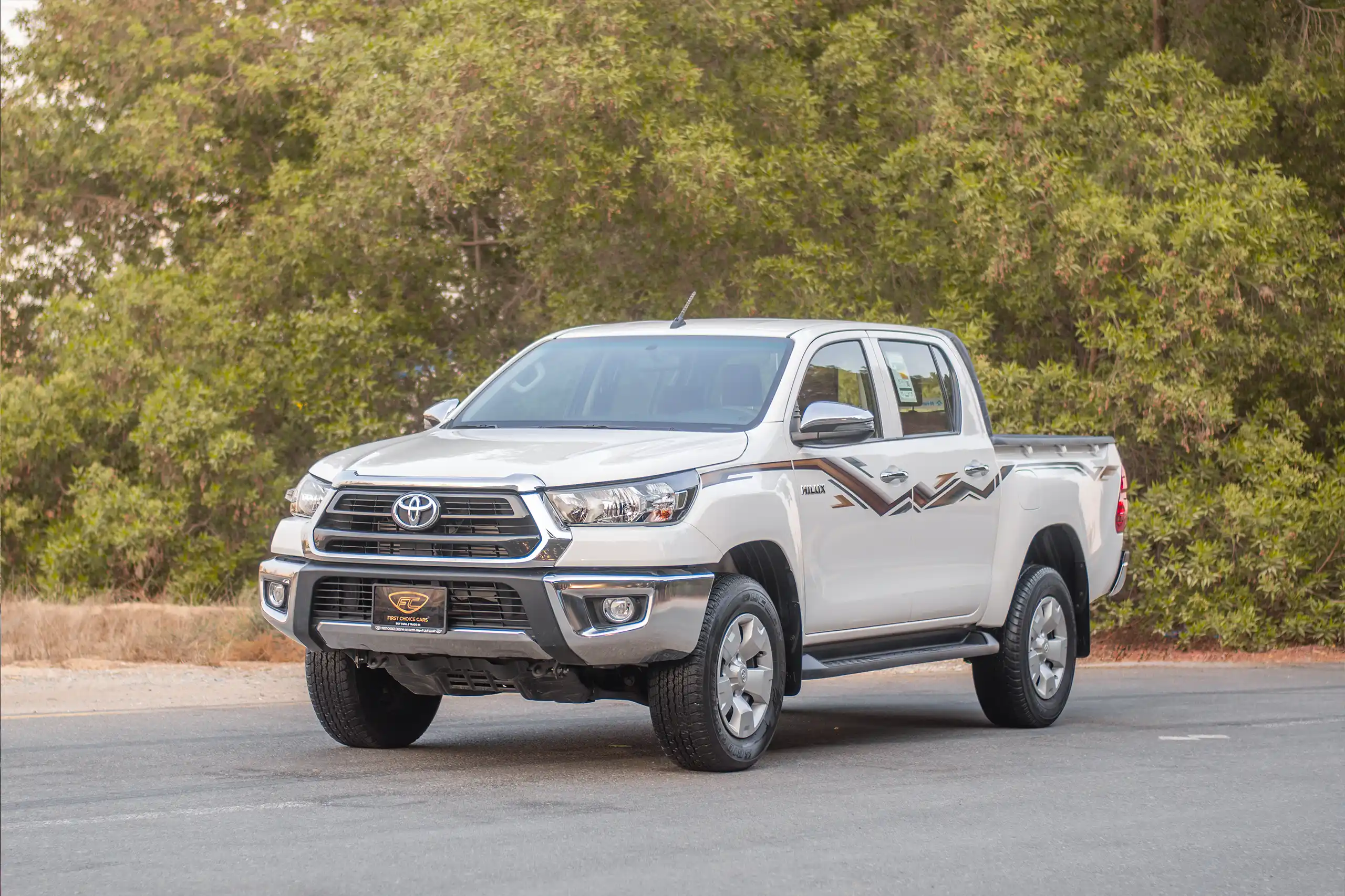 Used 2024 Toyota Hilux DLX Double Cabin in White – Left Front Diagonal (45°) View for Sale at First Choice Cars Dubai Sharjah