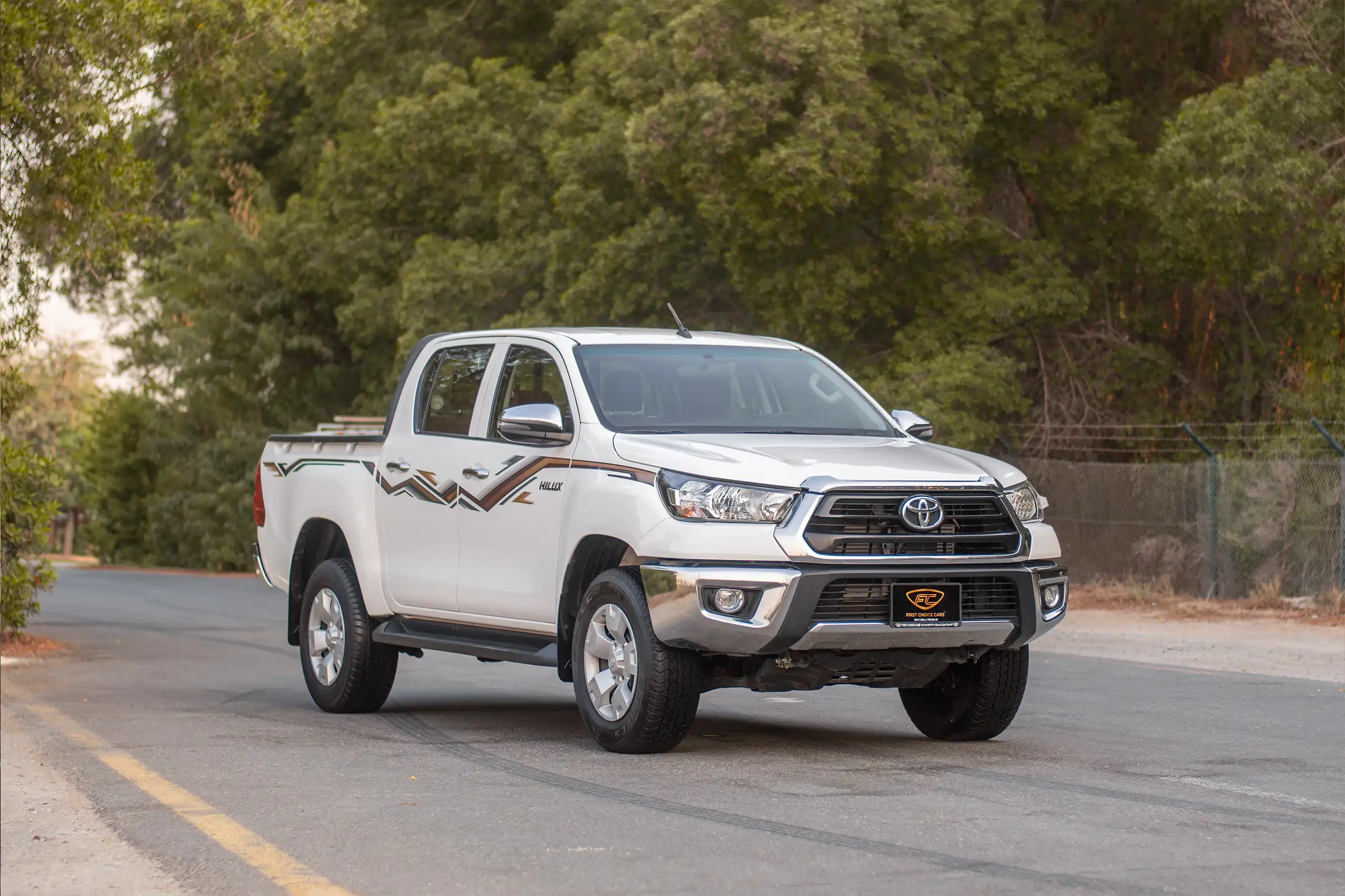 Used 2024 Toyota Hilux DLX Double Cabin in White – Right Front Diagonal (45°) View for Sale at First Choice Cars Dubai Sharjah