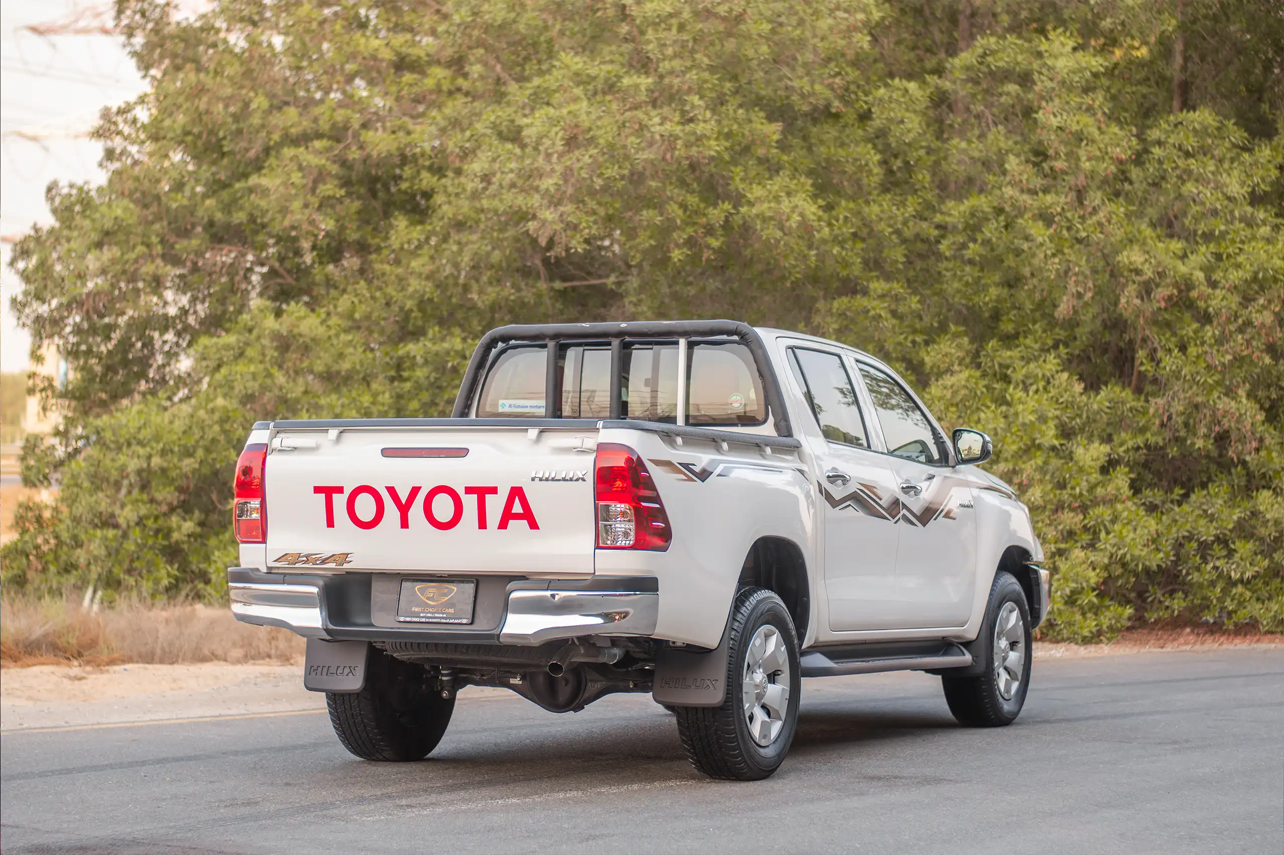 Used 2024 Toyota Hilux DLX Double Cabin in White – Right Back Diagonal (45°) View for Sale at First Choice Cars Dubai Sharjah