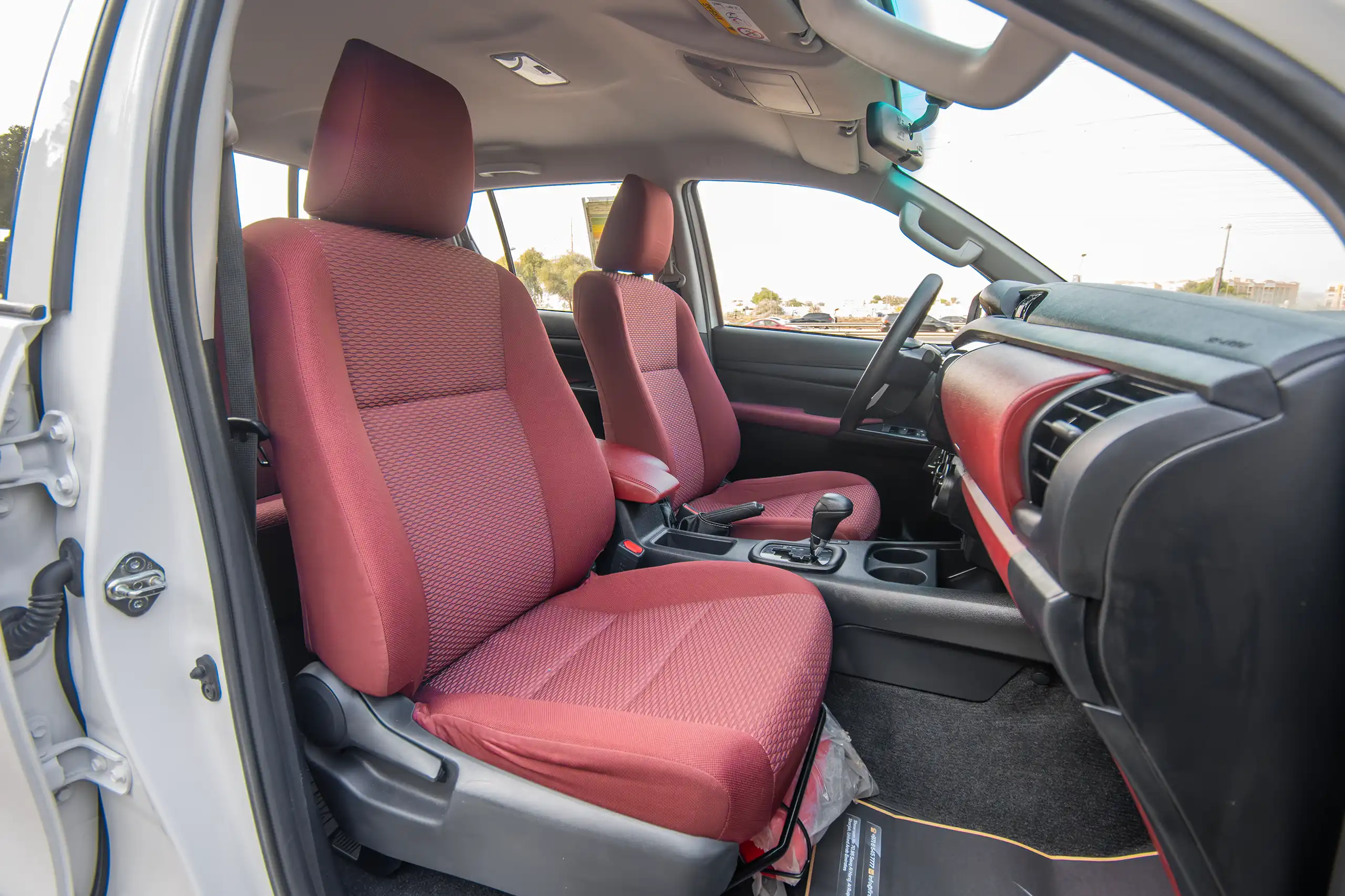 Used 2024 Toyota Hilux DLX Double Cabin in White – Front Passenger Side Cabin View for Sale at First Choice Cars Dubai Sharjah