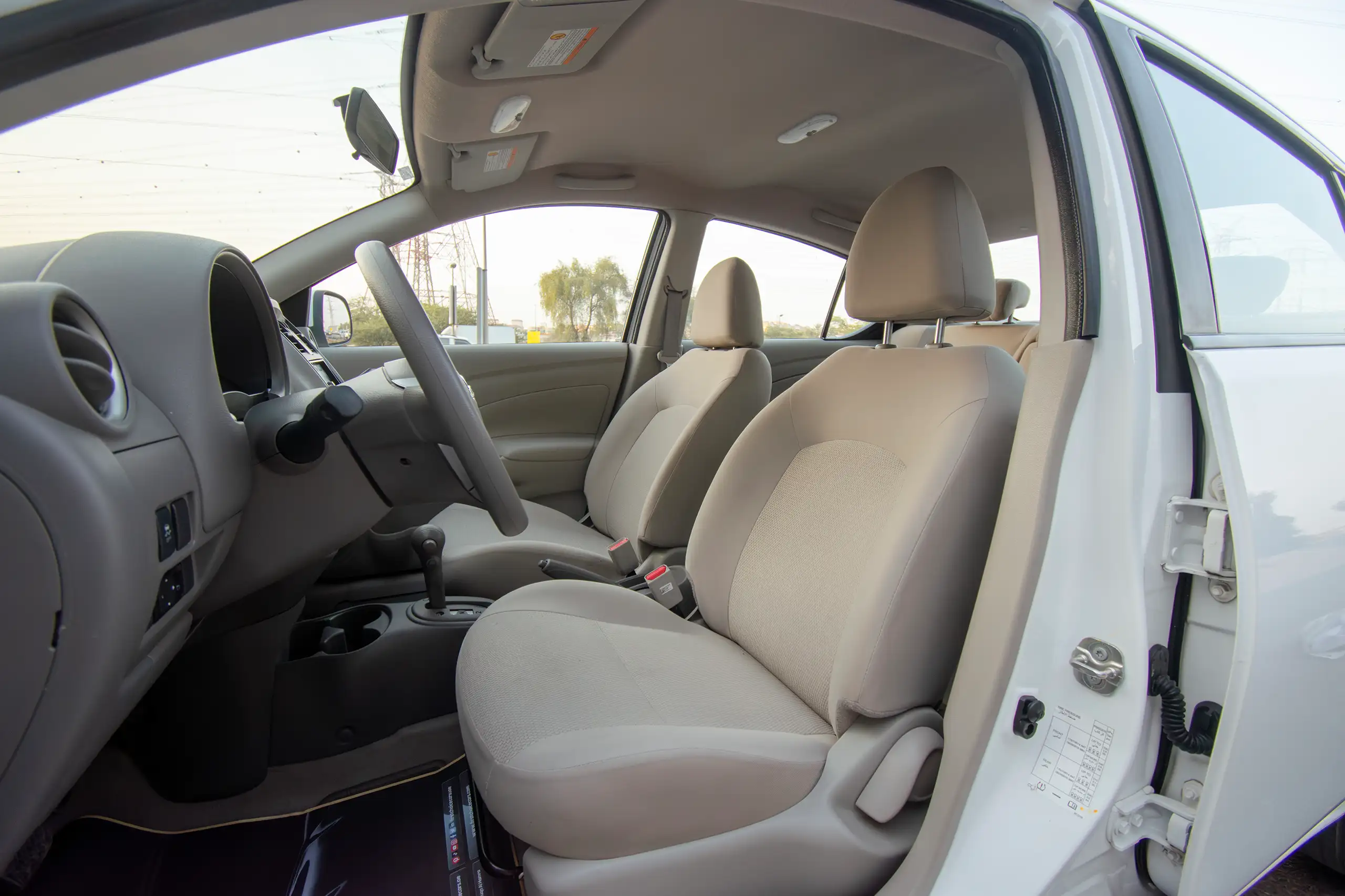 Used 2023 Nissan Sunny Sv White – Front Driver Side Cabin View at First Choice Cars Sharjah