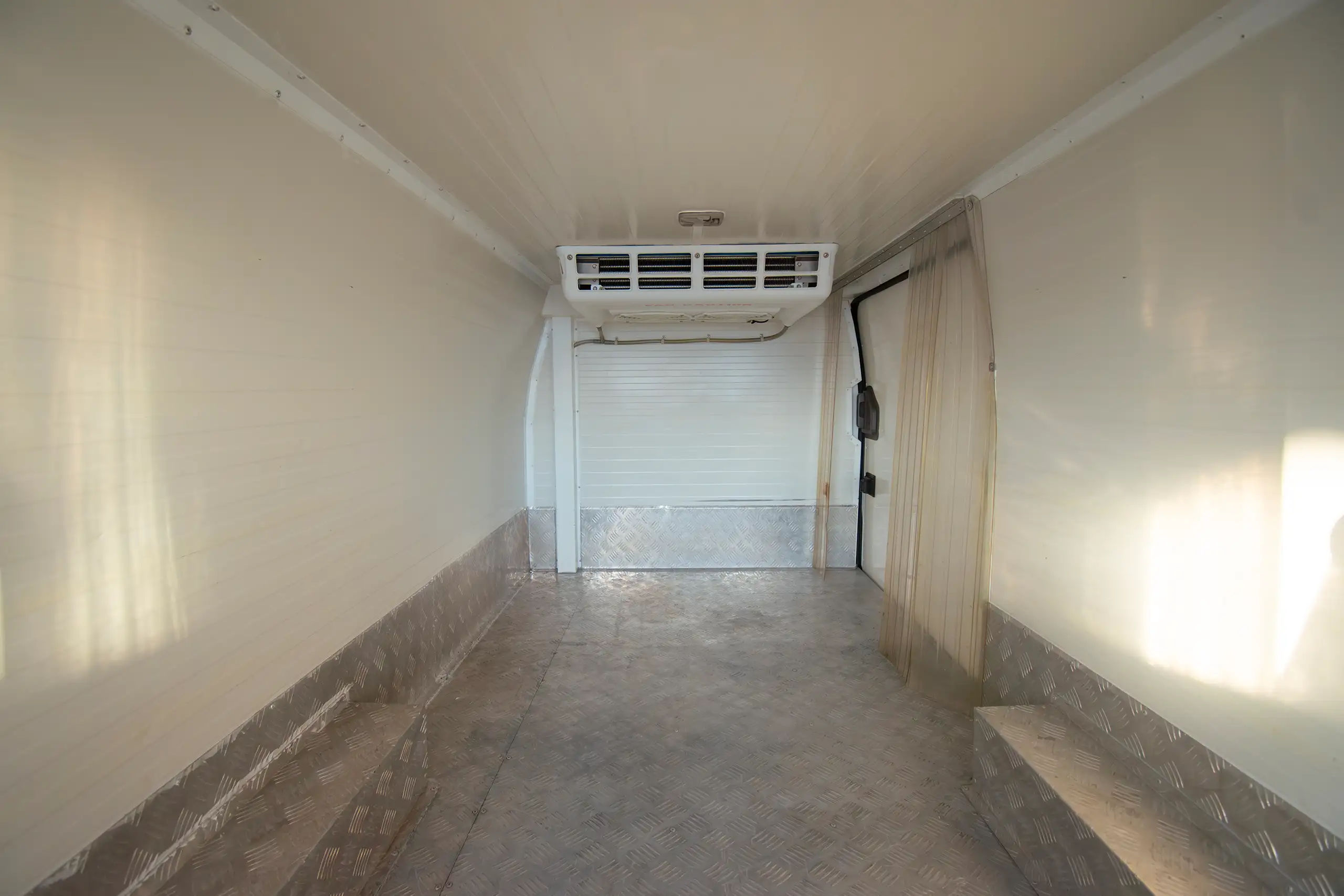 Used 2022 Nissan Urvan Standard Roof White – Chiller Box Rear Opening View at First Choice Cars Sharjah