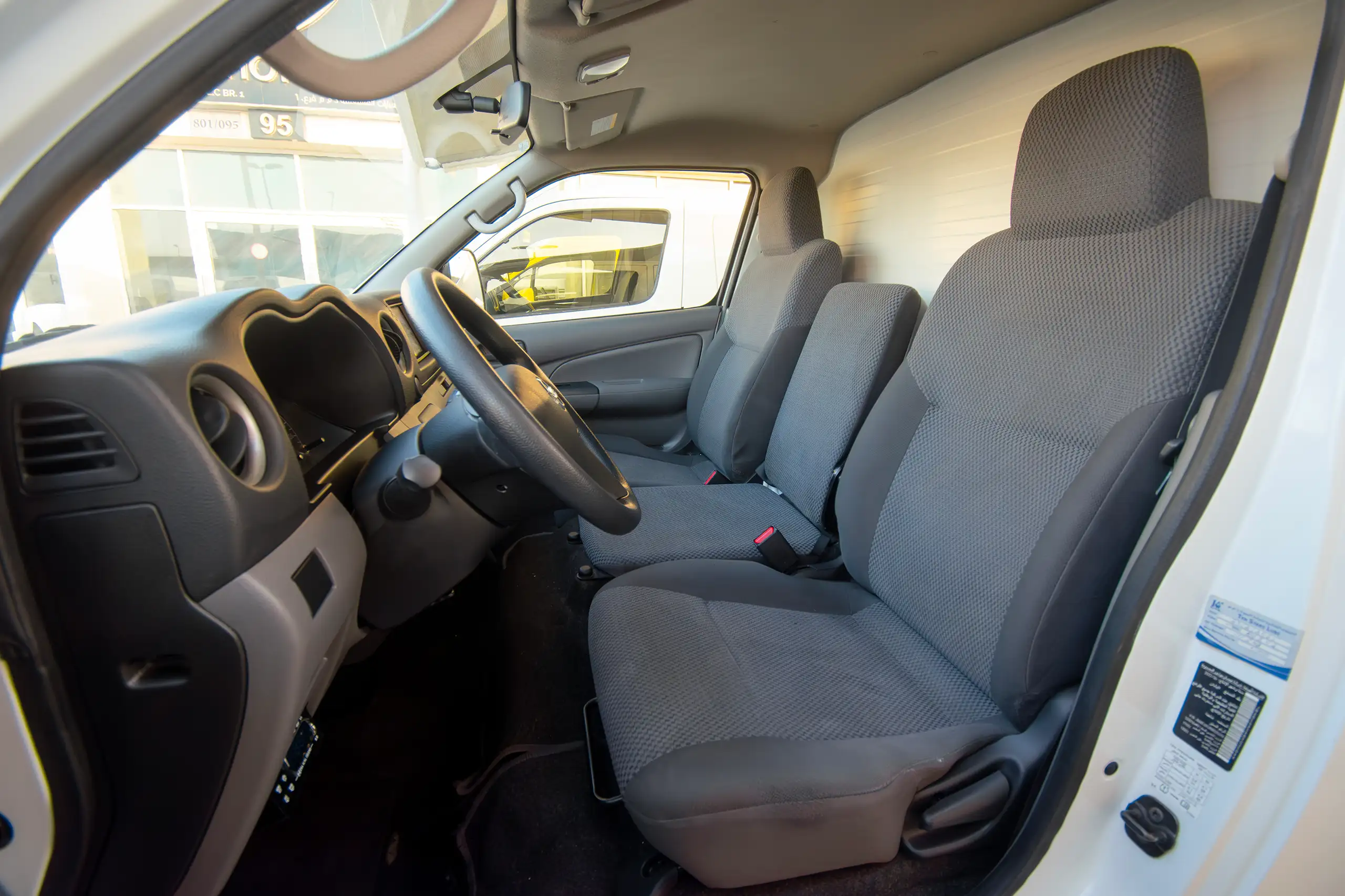 Used 2022 Nissan Urvan Standard Roof White – Front Driver Side Cabin View at First Choice Cars Sharjah