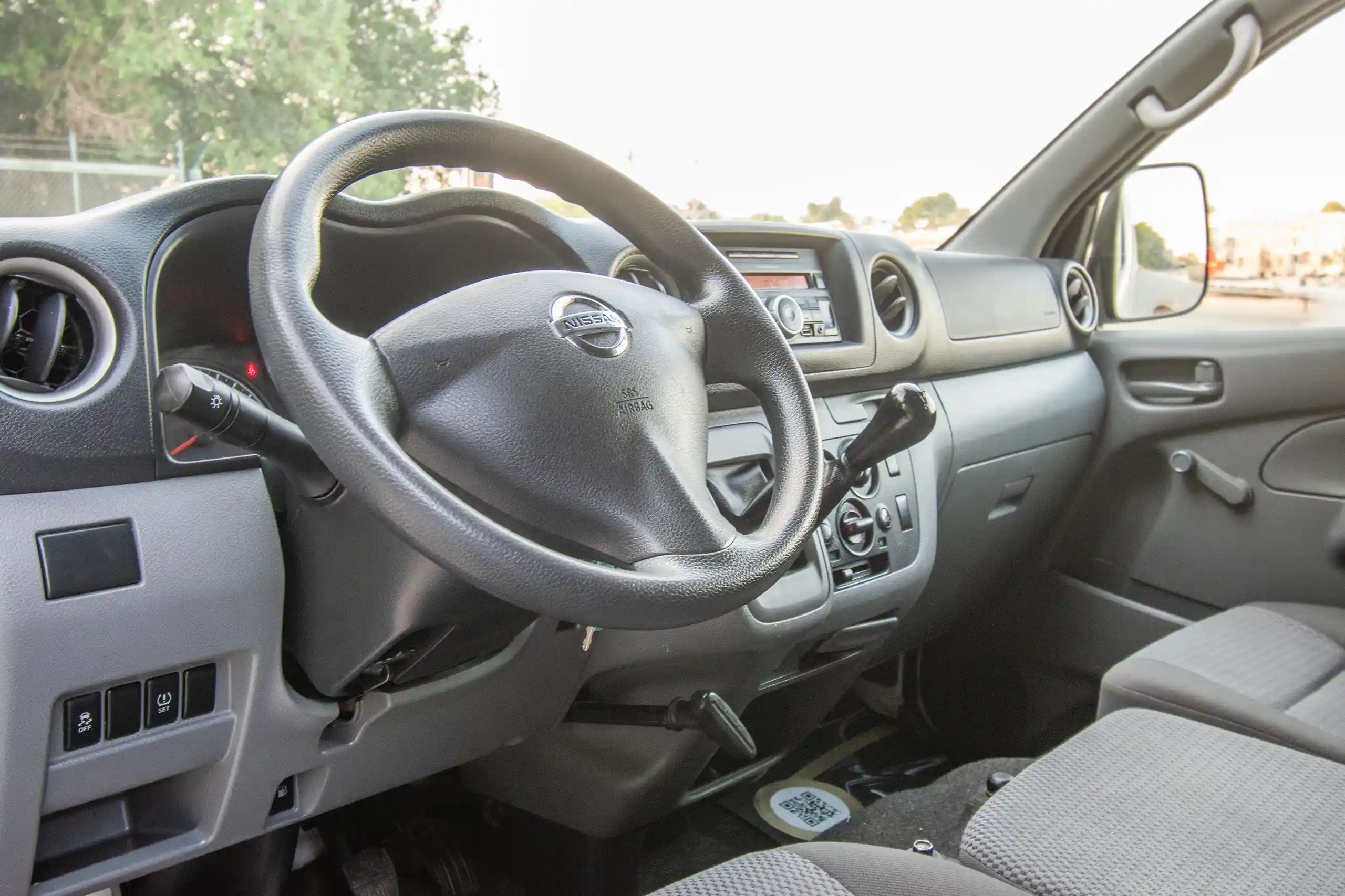 Used 2022 Nissan Urvan Standard Roof White – Driver Side Dashboard & Steering View at First Choice Cars Sharjah