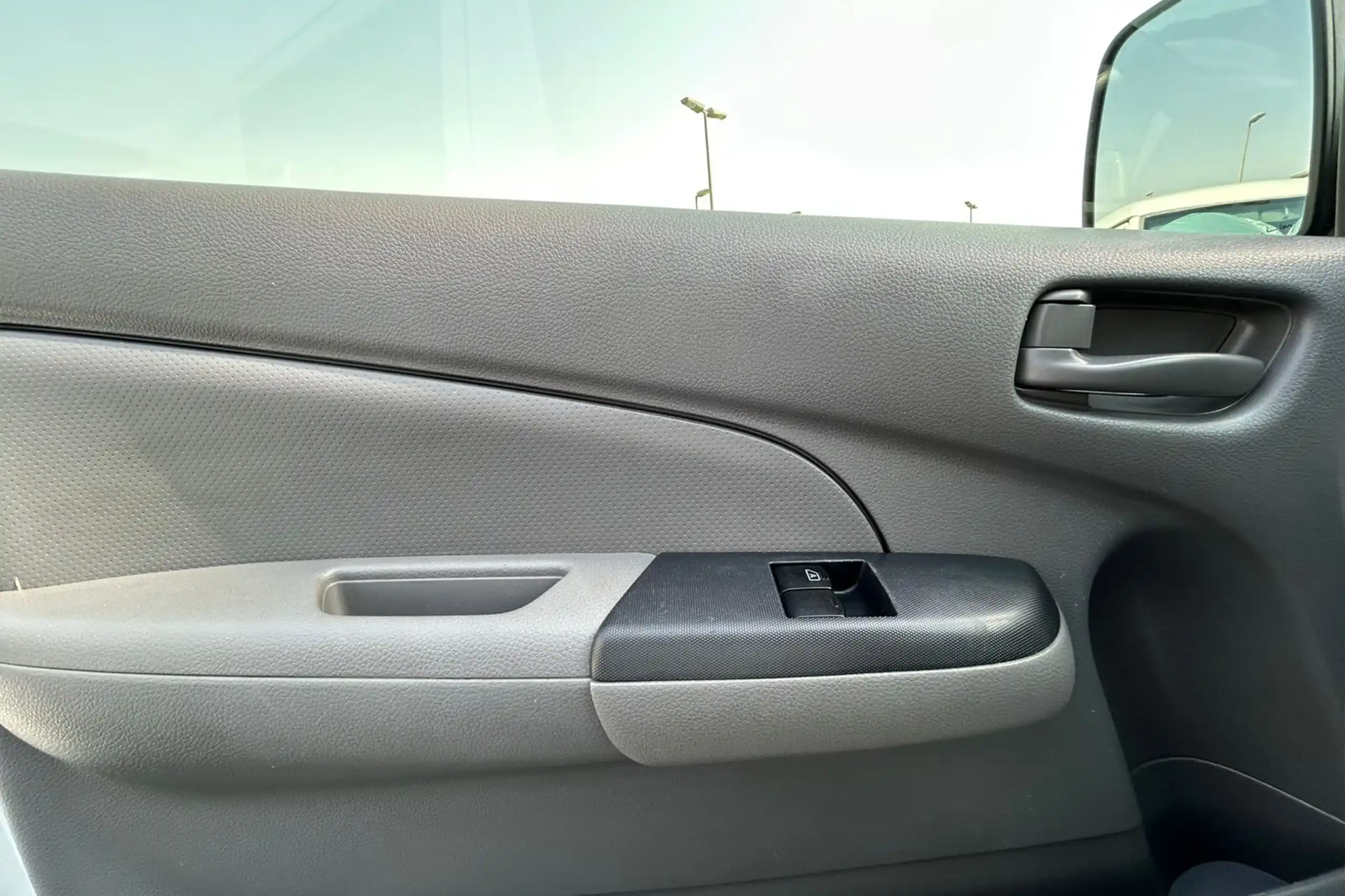 Used 2022 Nissan Urvan Standard Roof White – Driver Door Panel Full View at First Choice Cars Sharjah