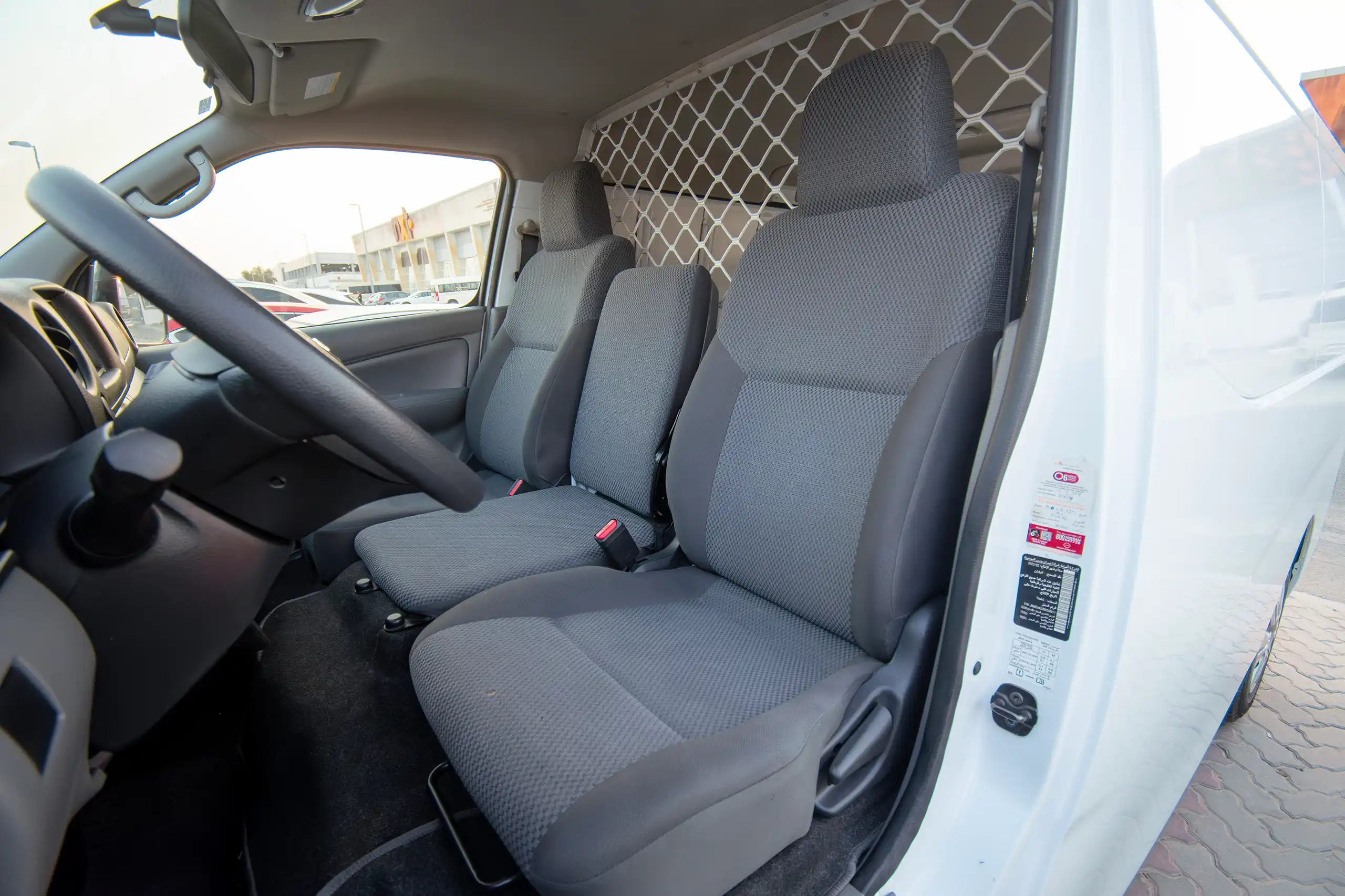 Used 2022 Nissan Urvan Standard Roof White – Front Driver Side Cabin View at First Choice Cars Sharjah