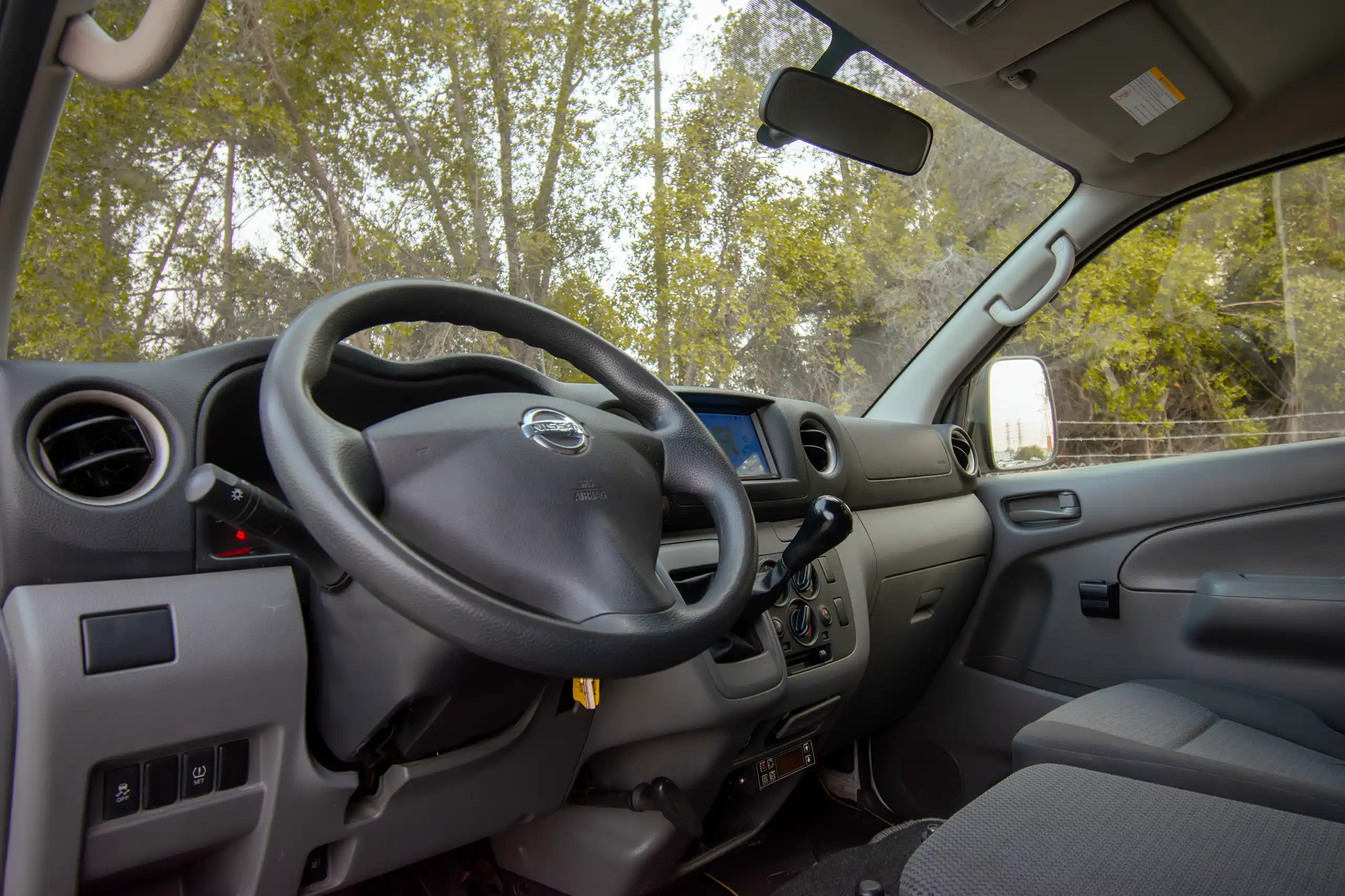 Used 2022 Nissan Urvan Standard Roof White – Driver Side Dashboard & Steering View at First Choice Cars Sharjah