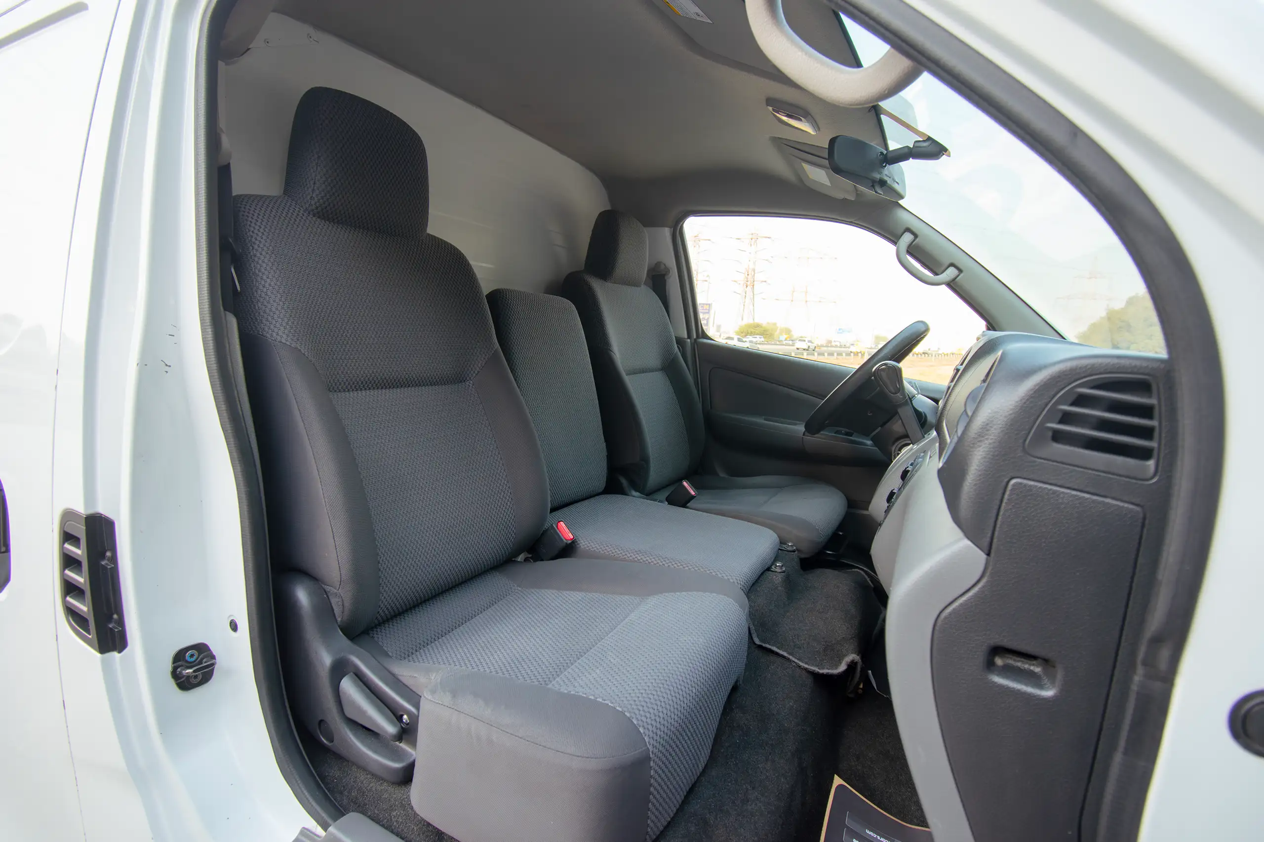 Used 2022 Nissan Urvan Standard Roof White – Front Passenger Side Cabin View at First Choice Cars Sharjah
