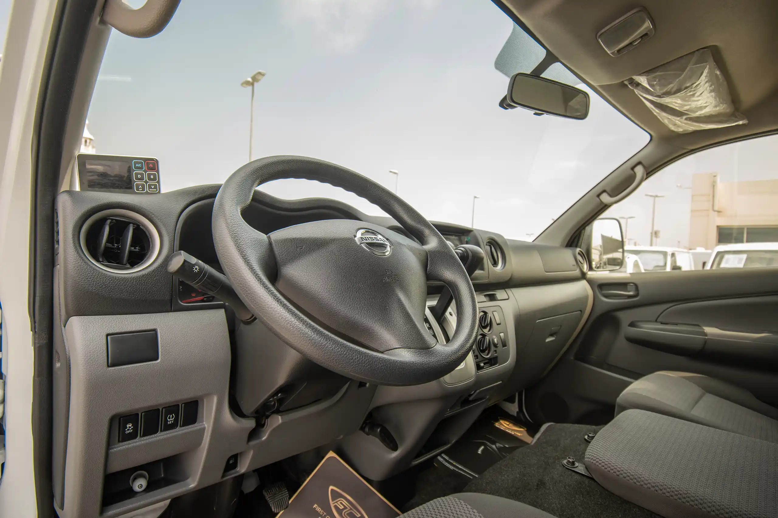 Used 2022 Nissan Urvan High Roof White – Driver Side Dashboard & Steering View at First Choice Cars Sharjah