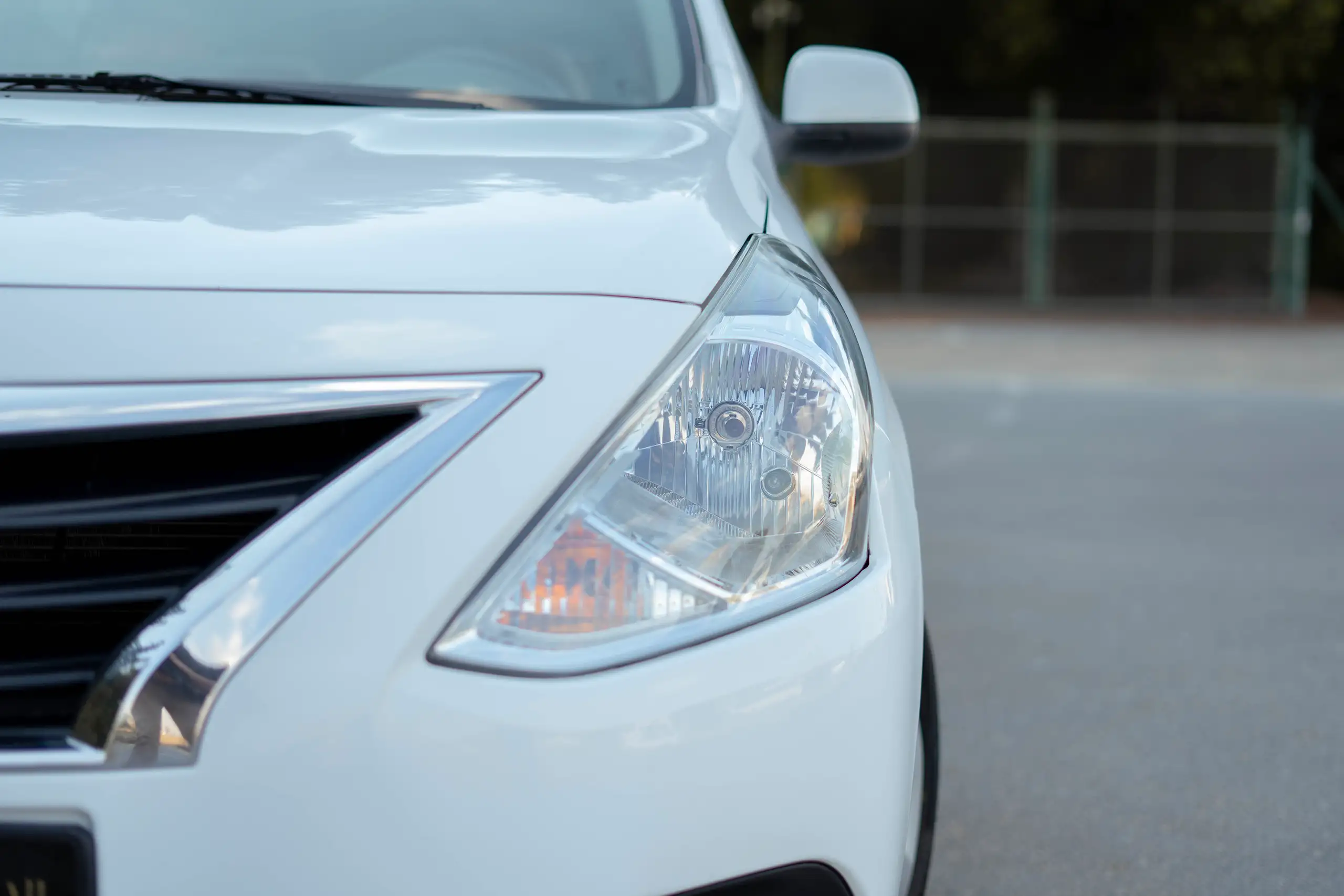 Used 2022 Nissan Sunny SV in White – Headlight Close-up for Sale at First Choice Cars Dubai Sharjah