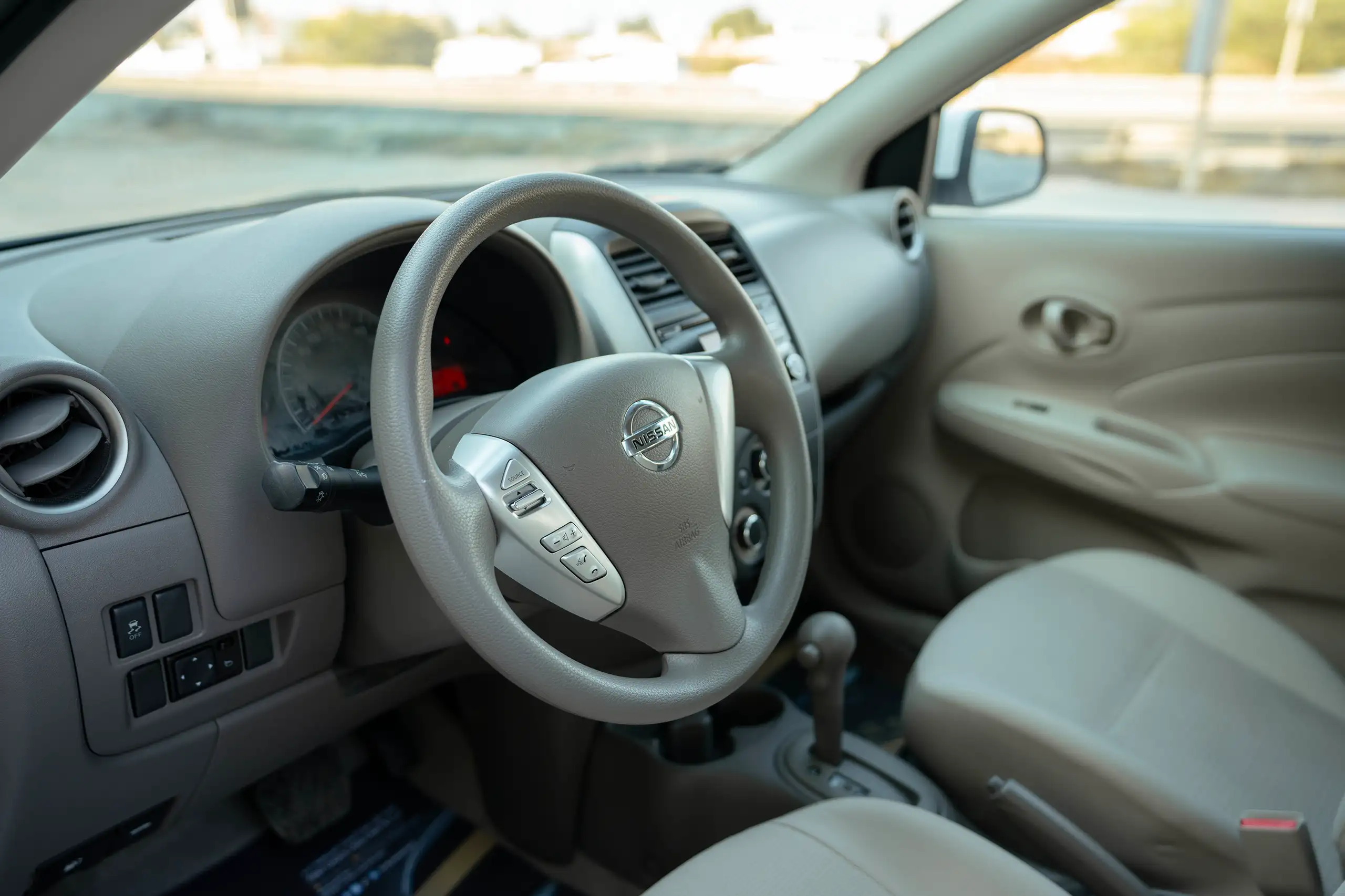 Used 2022 Nissan Sunny SV in White – Driver Side Dashboard & Steering View for Sale at First Choice Cars Dubai Sharjah