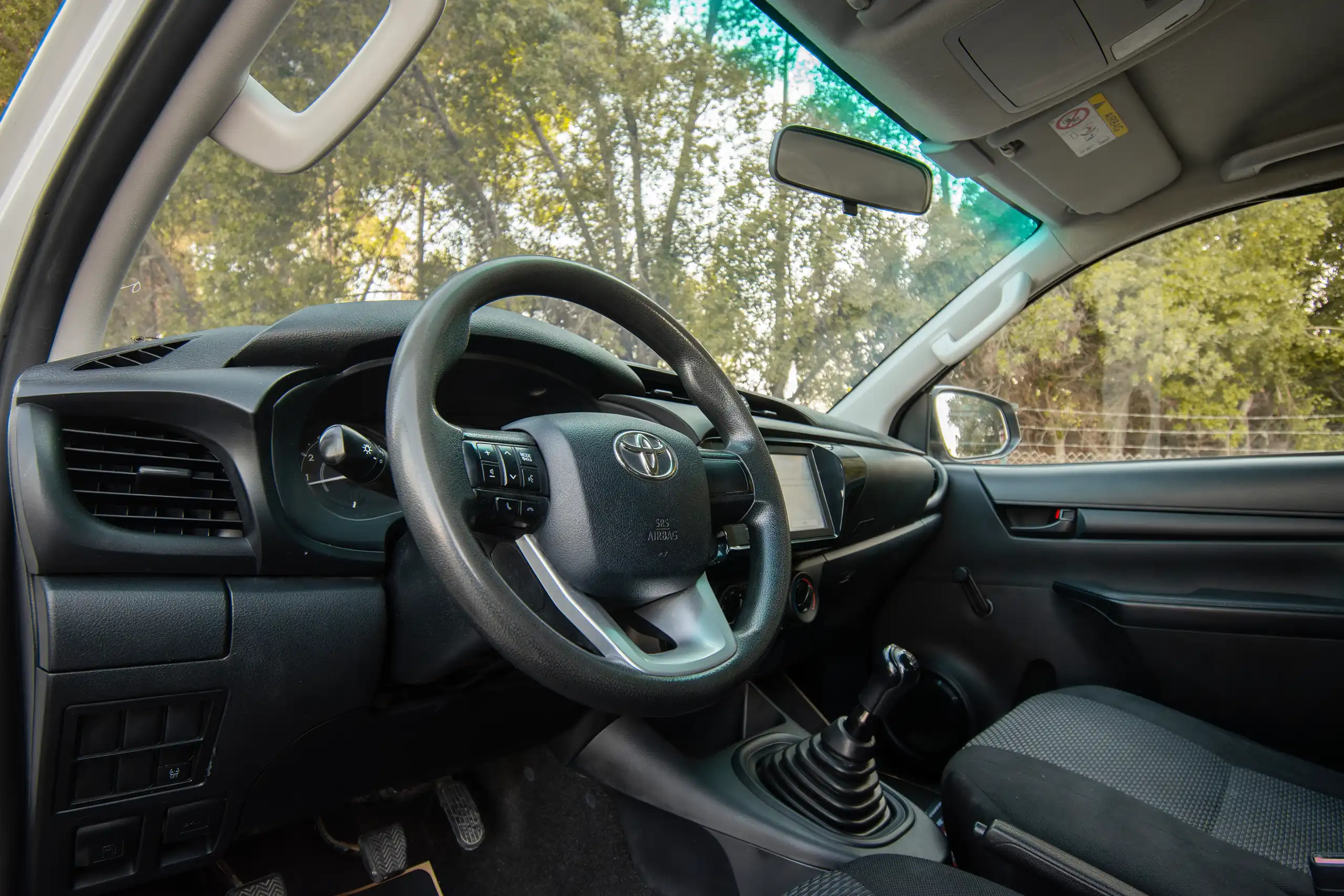 Used 2021 Toyota Hilux GL Double Cabin White – Driver Side Dashboard & Steering View at First Choice Cars Sharjah