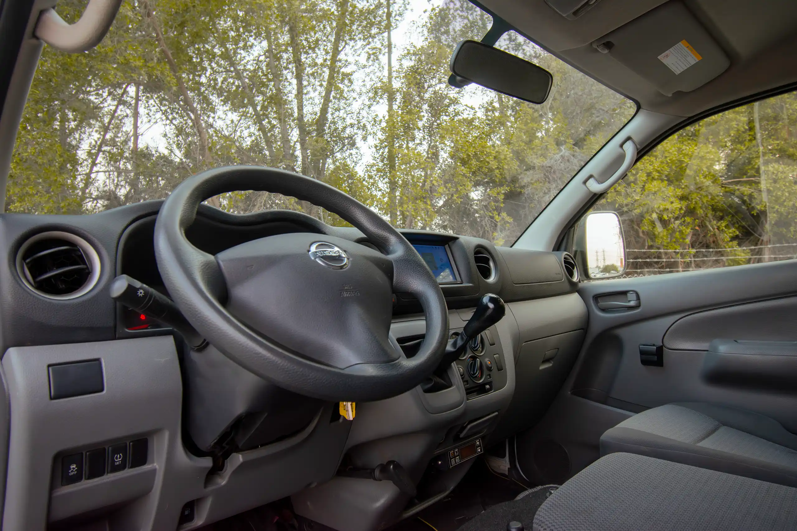 Used 2021 Nissan Urvan Standard Roof White – Driver Side Dashboard & Steering View at First Choice Cars Sharjah