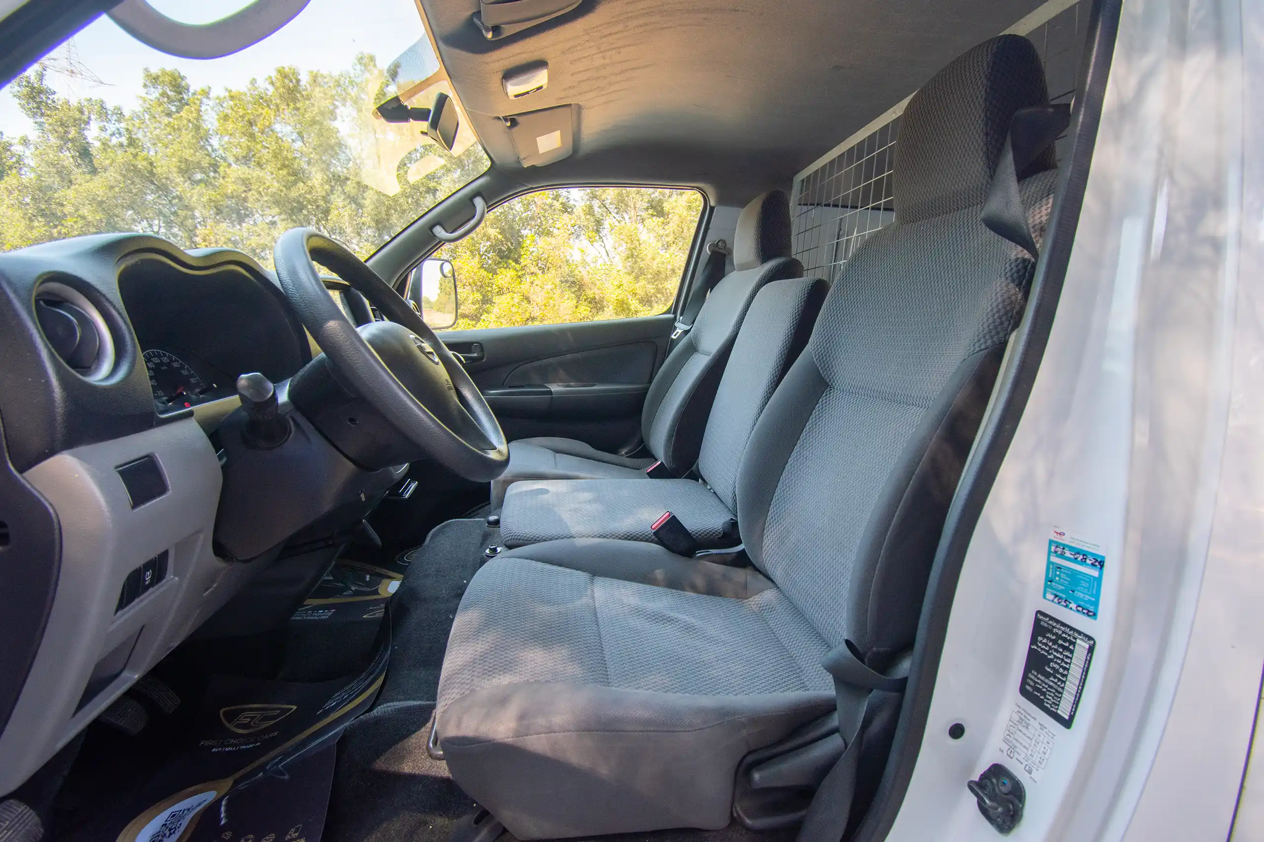 Used 2021 Nissan Urvan Standard Roof White – Front Driver Side Cabin View at First Choice Cars Sharjah